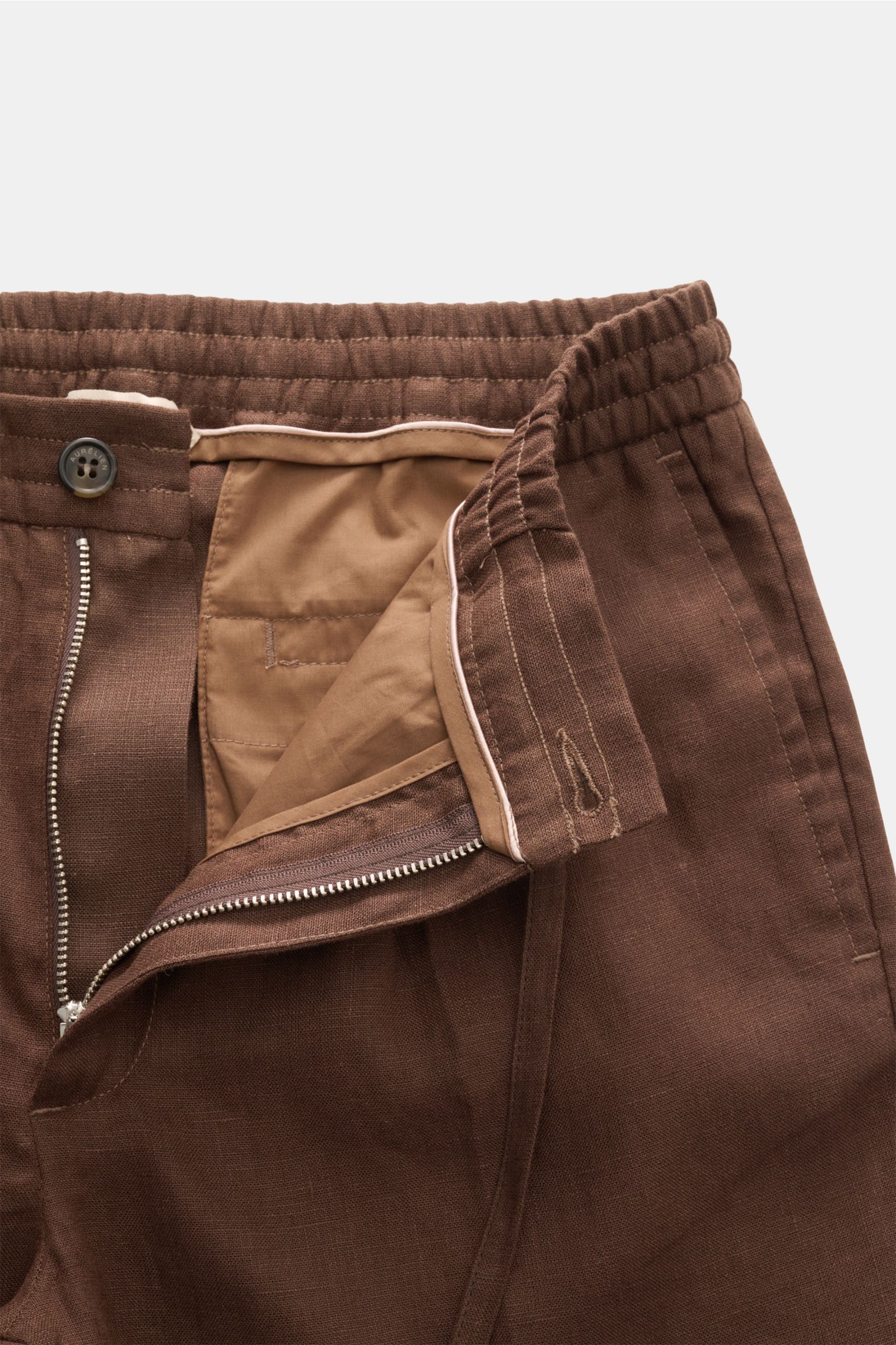 Close-up front view of Aurélien Leinen-Jogpants dunkelbraun in pure linen with elastic waistband, zipper, button, and natural texture.