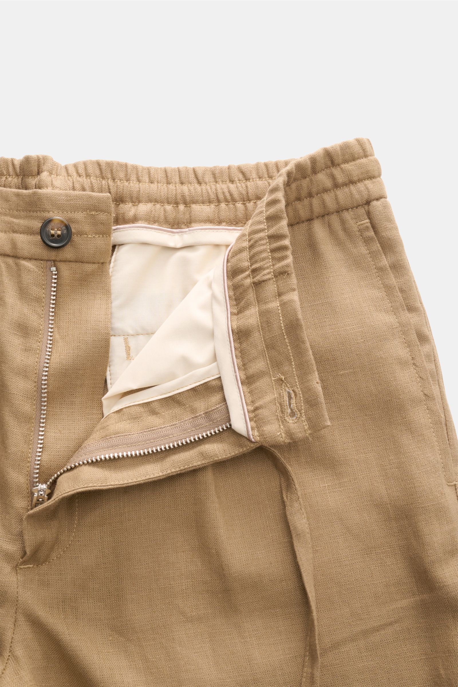 Aurélien Leinen-Jogpants hellbraun close-up from above showing elastic waistband, zipper, button, and light brown pure linen fabric with a regular fit.