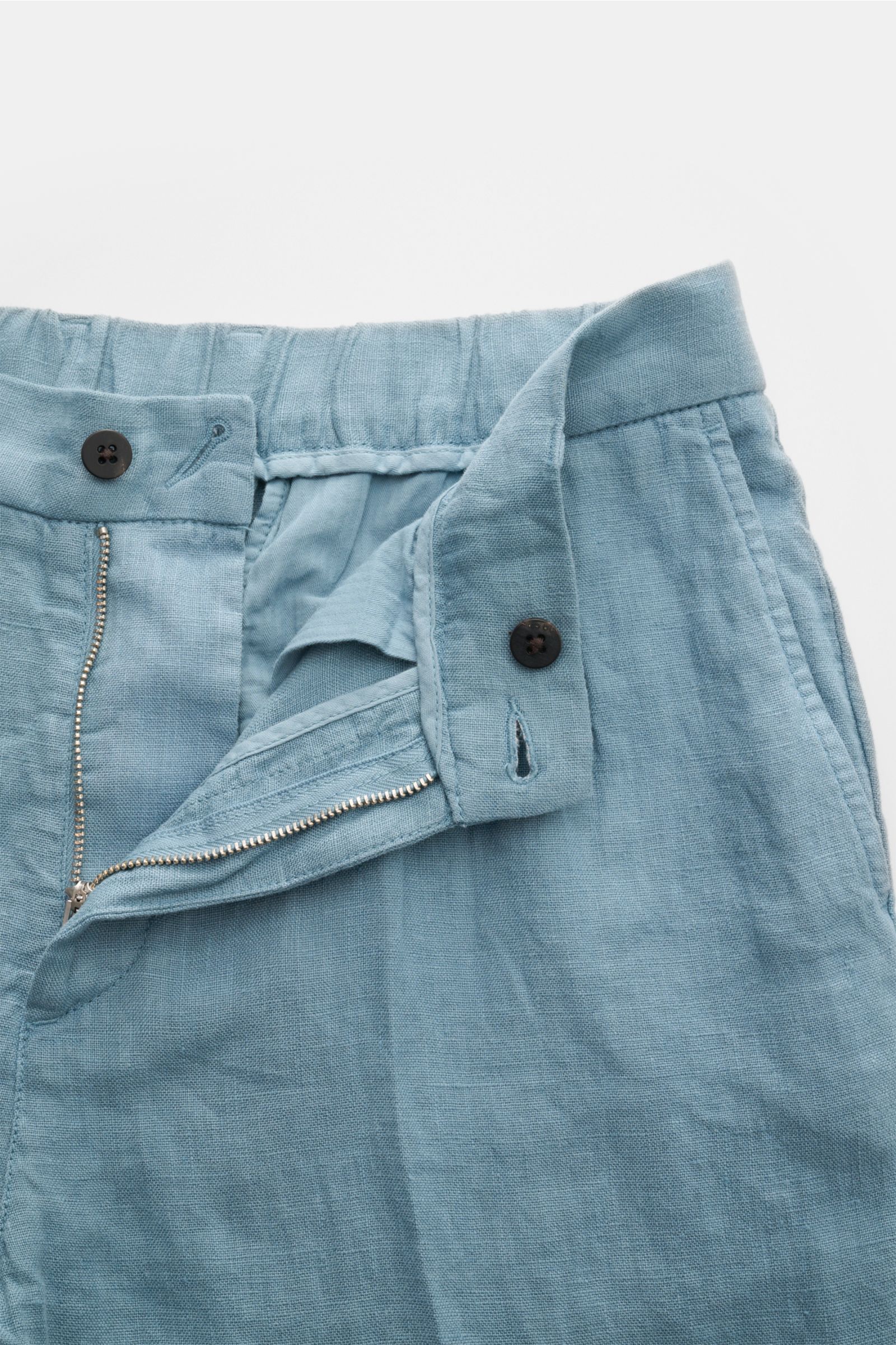 Close-up front view of 04651/ A trip in a bag Linen jogger pants 'Linen Pants' smoky blue showing zip, button, and waistband details. Perfect for warm days: These linen jogger pants by 04651/ A TRIP IN A BAG are the ideal summer essential – for travel or 