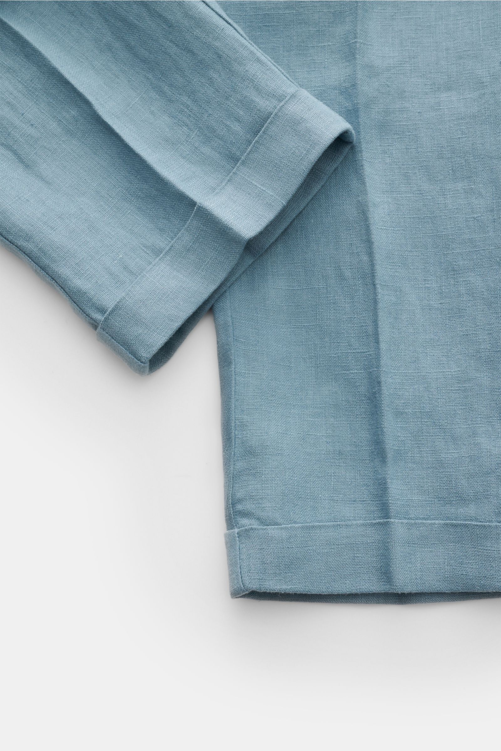 Close-up top-down view of 04651/ A trip in a bag Linen jogger pants 'Linen Pants' smoky blue showing folded pant legs and linen texture.

Description: Perfect for warm days: These linen jogger pants by 04651/ A TRIP IN A BAG are the ideal summer essent
