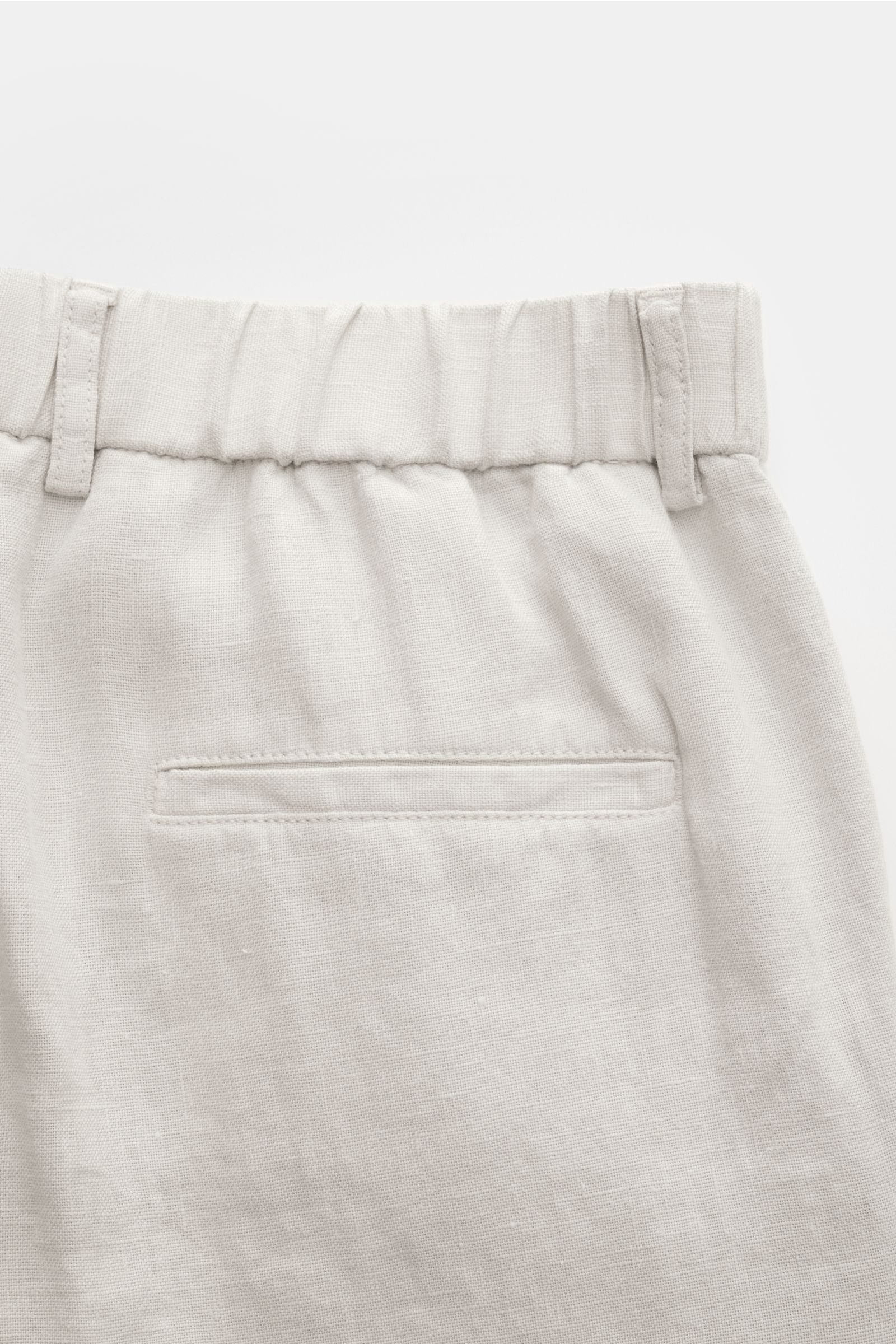 Close-up rear view of 04651/ A trip in a bag Linen jogger pants 'Linen Pants' light grey showing pure linen fabric, elastic waistband, belt loops, and jetted back pocket. Perfect for warm days: These linen jogger pants by 04651/ A TRIP IN A BAG are the id
