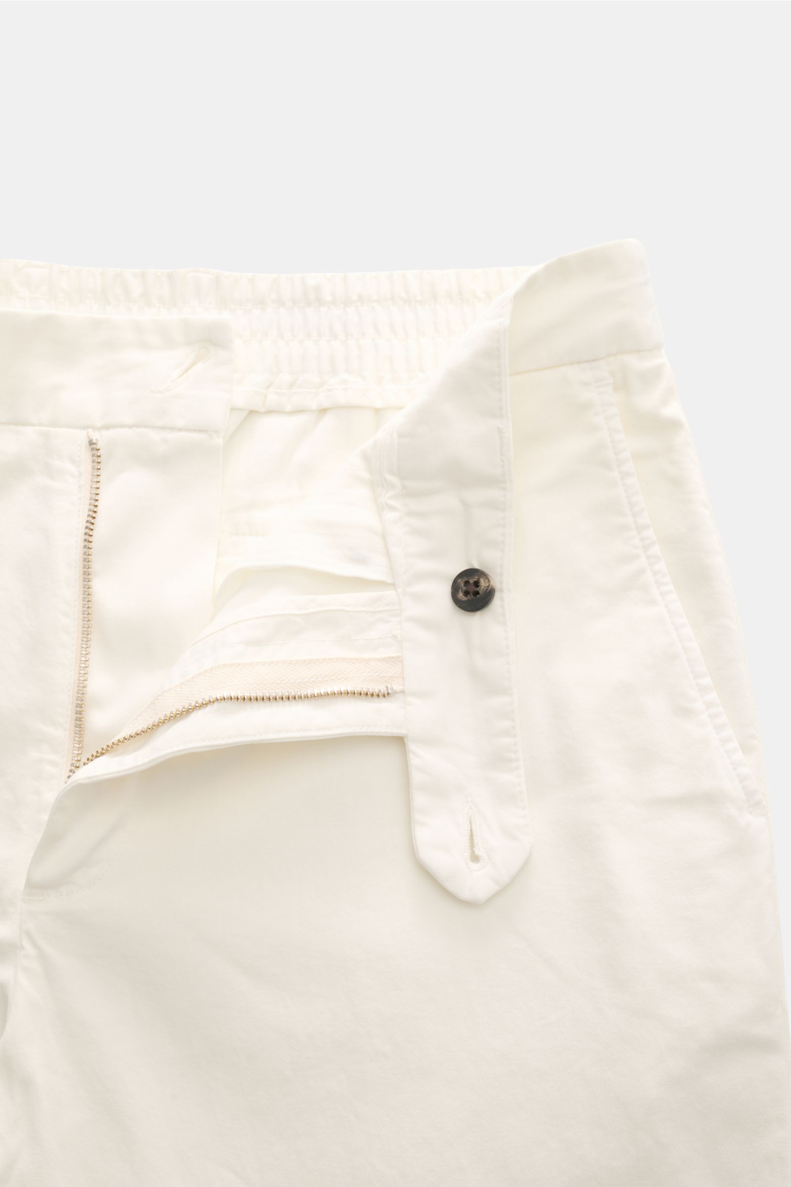 Close-up front view of 04651/ A trip in a bag Cotton jogger pants 'Flex Light' cream showing zip, waist button, elasticated waistband, and pockets.