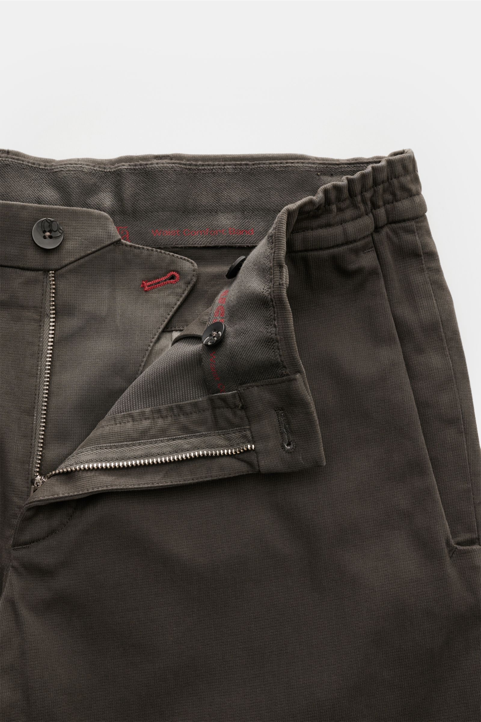 Close-up top view of GTA Trousers 'Dennis' dark grey showing the zip, waist button, slightly elasticated comfort waistband, and fine stitching details. With the cropped, tapered trousers 'Dennis', GTA presents an essential that combines the relaxed feel o
