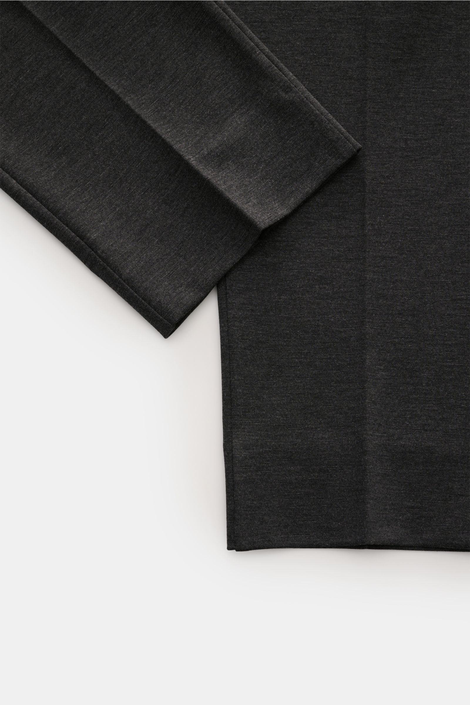 Close-up top-down view of the lower part of GTA Jogger pants 'Dennis' dark grey mottled, showing soft, smooth viscose and microfibre fabric with tapered fit, regular thigh width, ankle length, single pleat, and clean hems. The jogger pants feature an elas