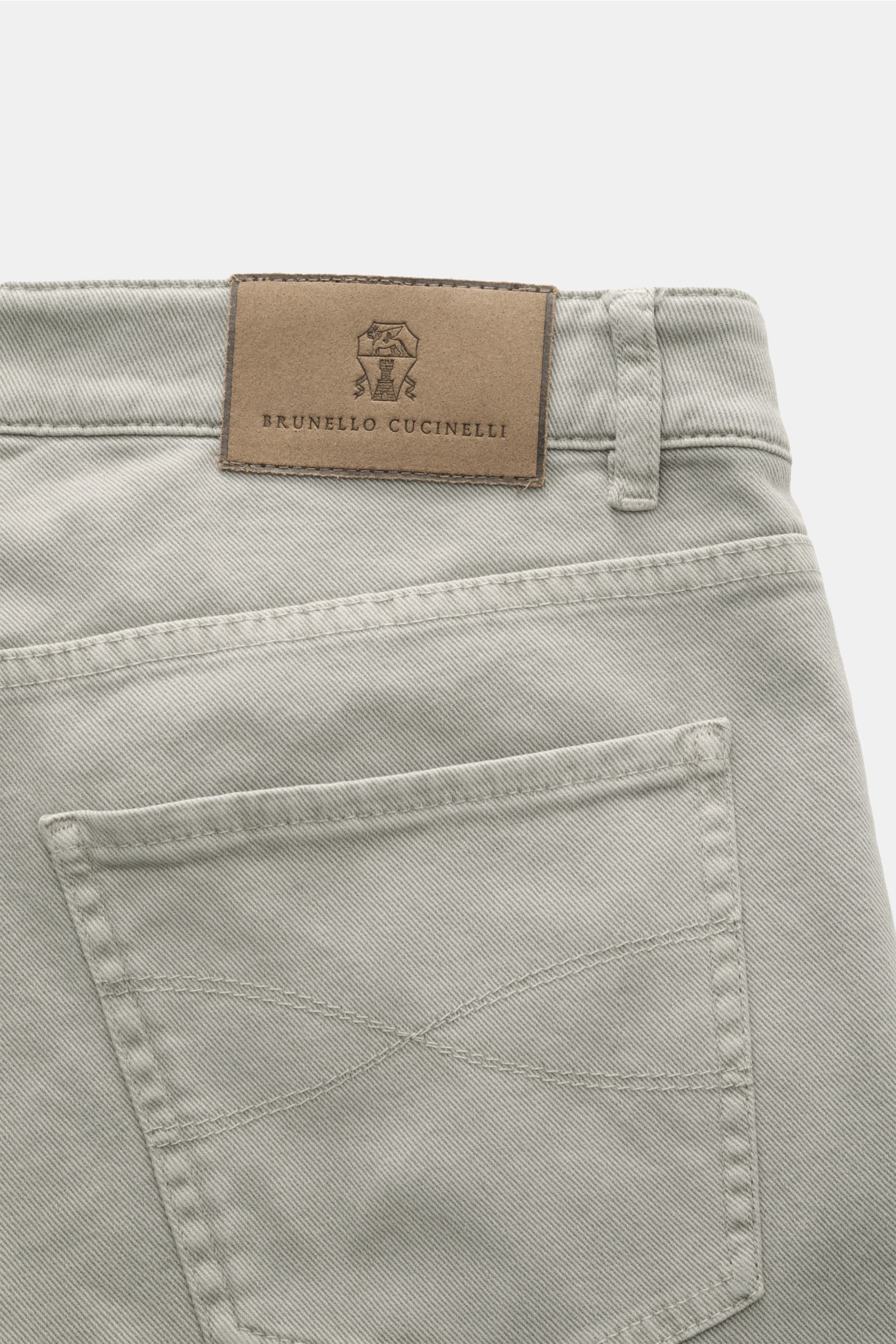 Close-up rear view of Brunello Cucinelli Jeans 'Traditional Fit' sage with leather patch, cotton denim, slightly elasticated fabric, and back pocket stitching.
