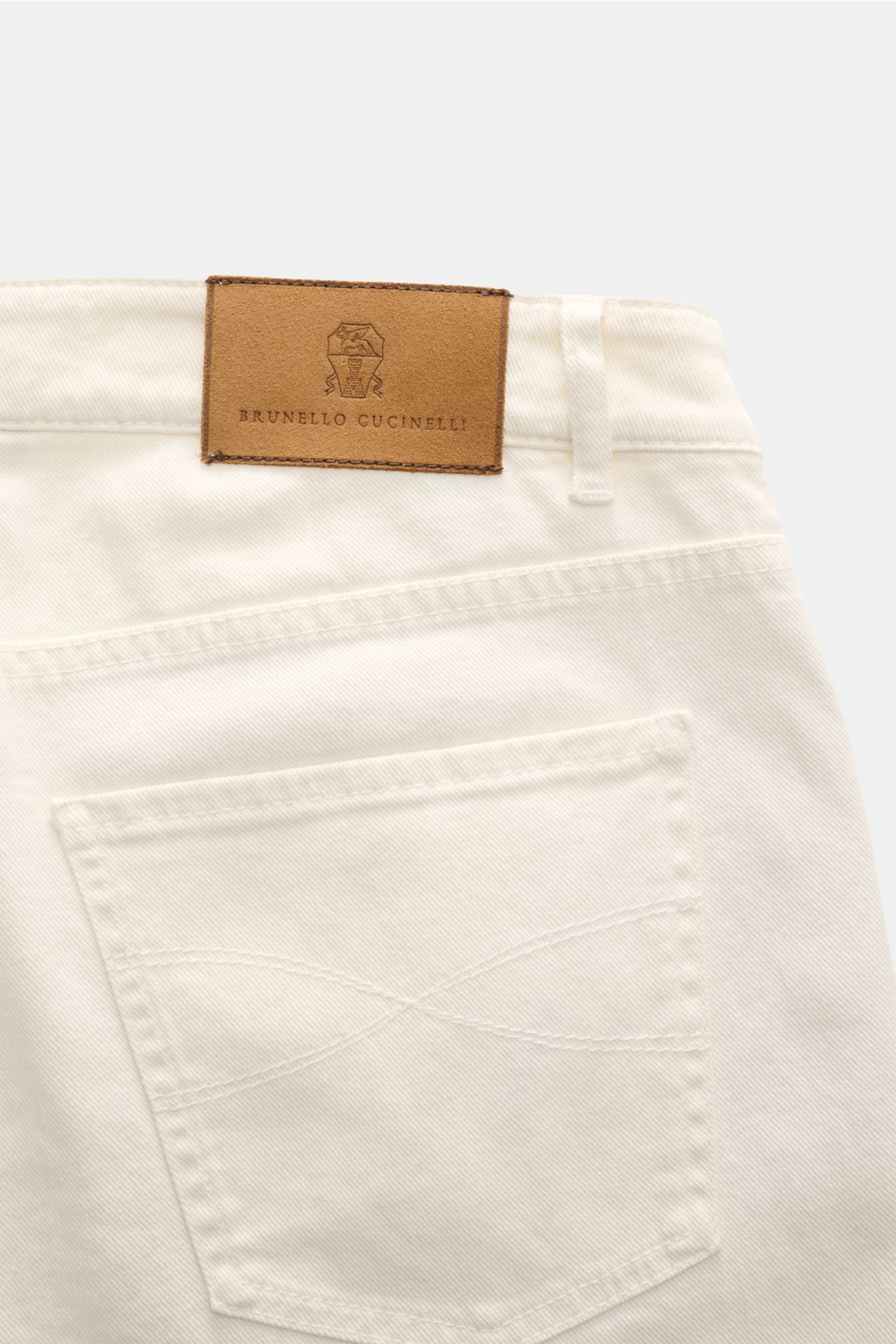 Close-up rear view of Brunello Cucinelli Jeans 'Traditional Fit' cream showing cotton denim fabric, leather patch, and stitching details.
