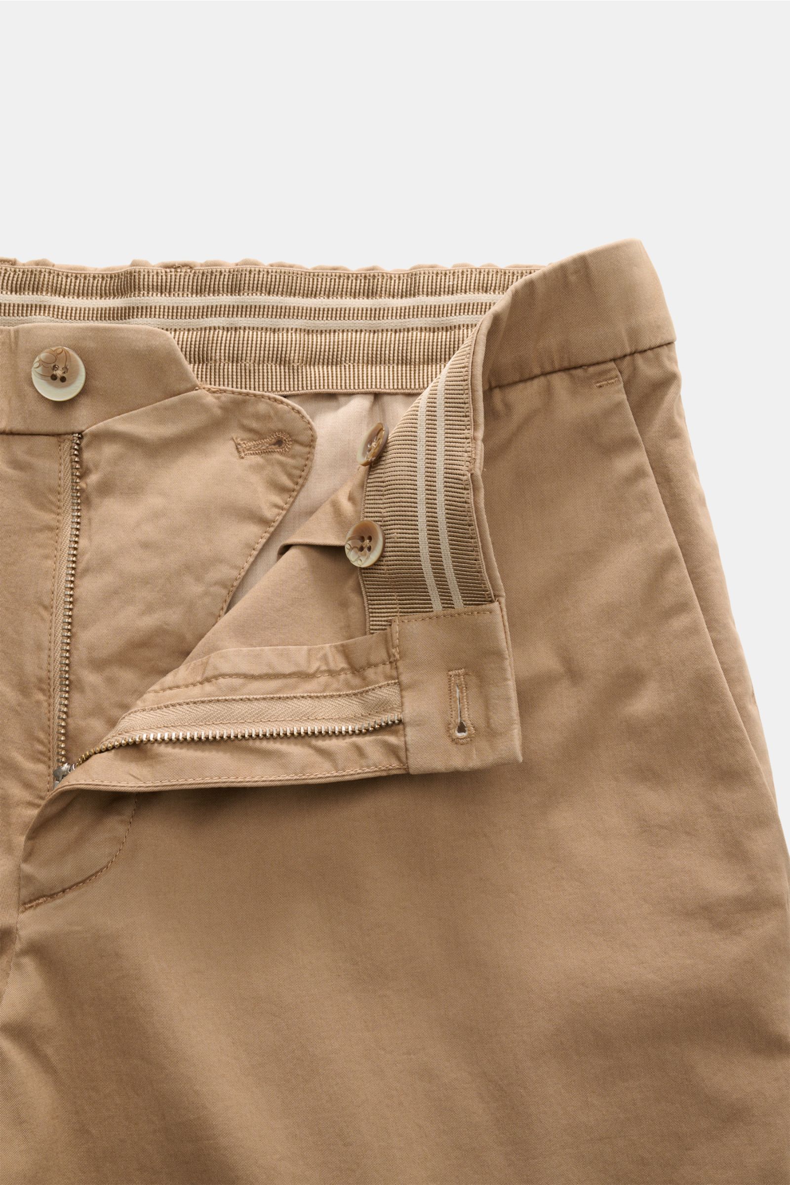 Close-up front view of GTA Chino 'Davide' hellbraun showing light brown cotton twill fabric, elastic waistband, zipper, button closure, and detailed stitching.


