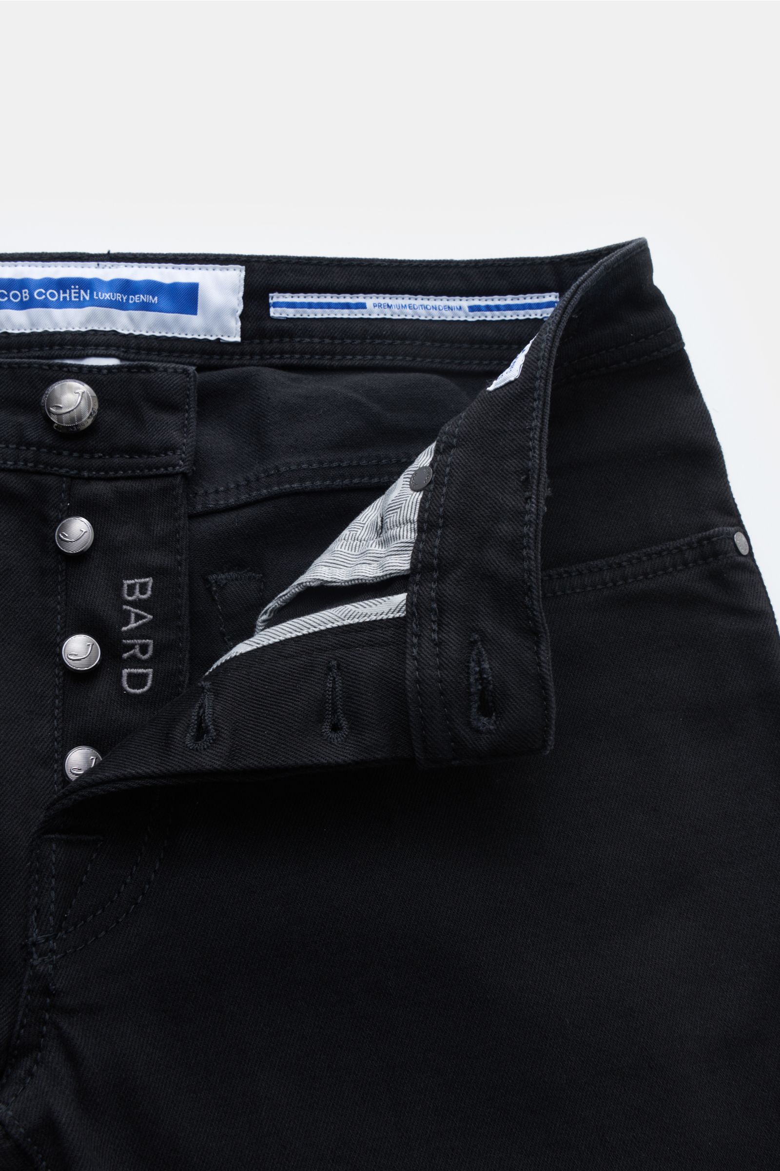 Close-up view of the front upper section of Jacob Cohen Jeans 'Bard' black (formerly J688) showing button fly and waistband details. Denim made of cotton and microfibre with slight stretch content, lightweight robust fabric, slim fit, slightly tapered cut