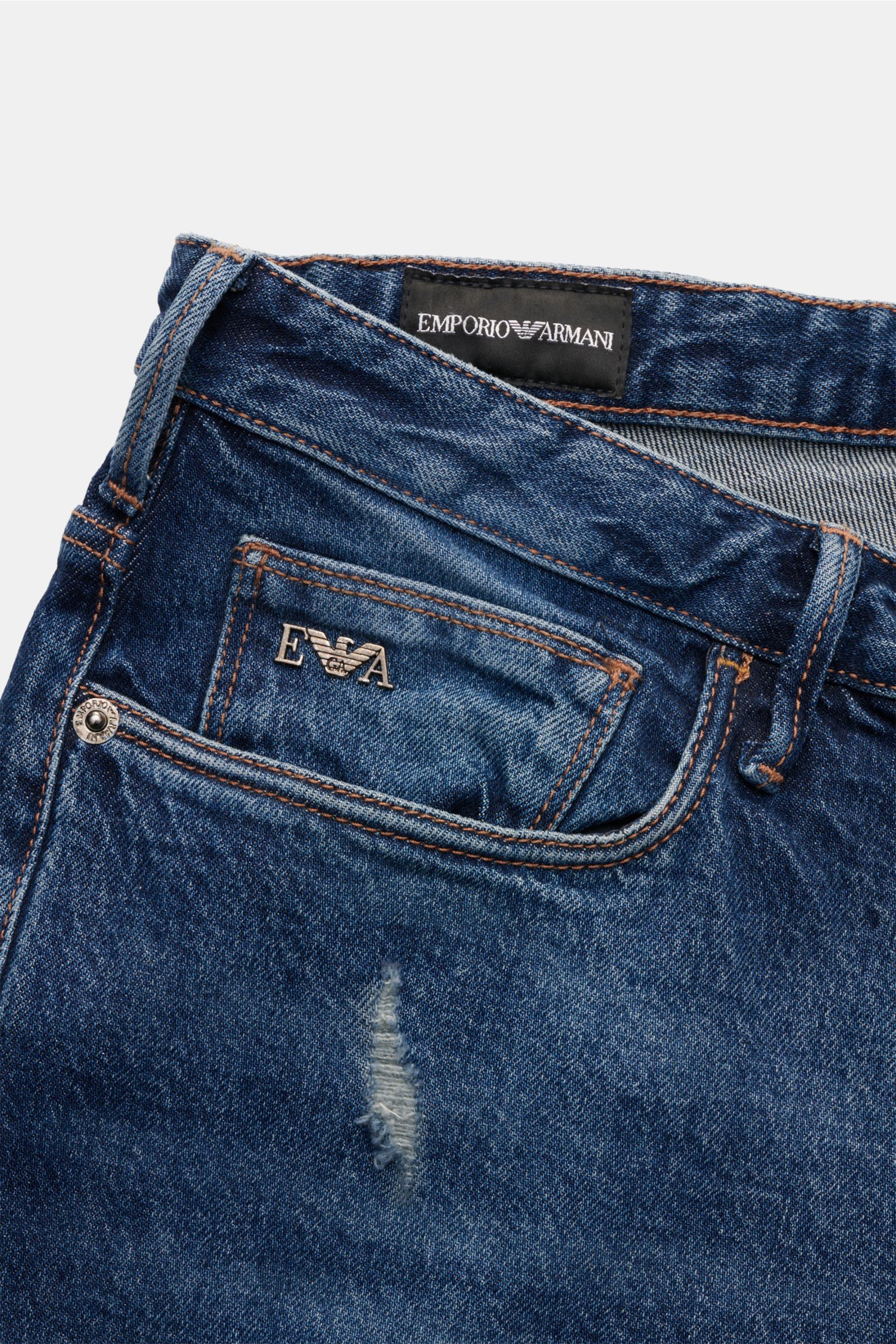 Emporio Armani Jeans dunkelblau aus Baumwolle, Slim Fit, Five-Pocket-Stil, Zip Fly, Metall-Logos, Leather Patch, leichte Waschung, Distressed Details, Detailfoto von vorne oben.