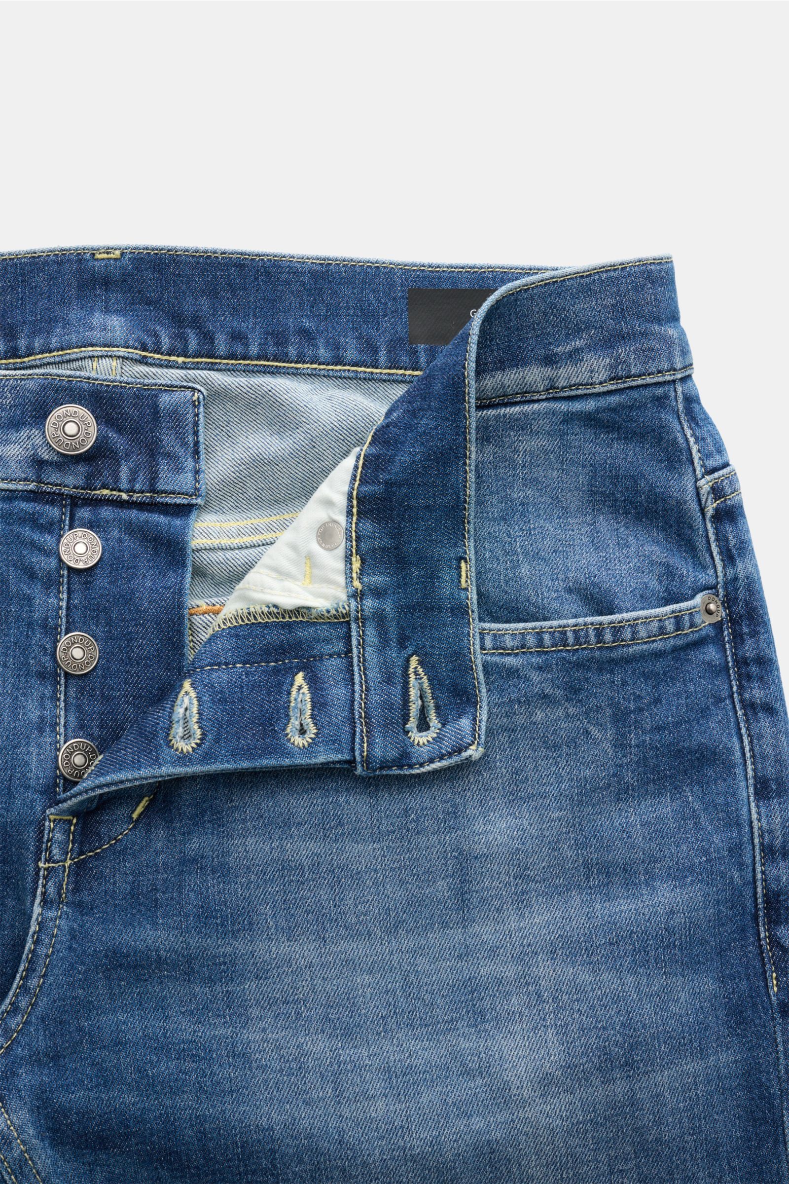 Close-up front view of Dondup Jeans 'George' blue showcasing denim made of cotton with slight stretch, soft feel, skinny fit, slim calf, authentic wash, button fly, five-pocket style, jetted coin pocket, back pockets with stitching, signature metal initia