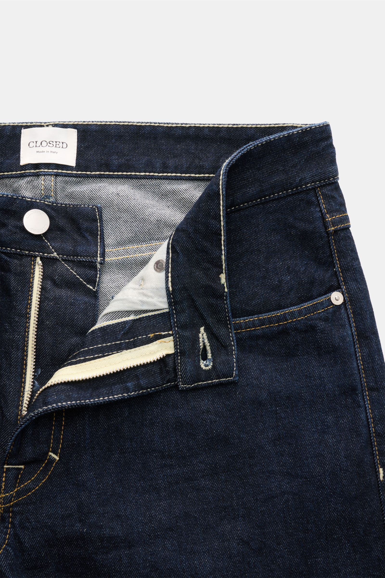 Closed Jeans 'Cooper' dark navy shown from a close-up top-front view with open zip fly, slim fit, five-pocket style, pure cotton denim, structured feel, typical CLOSED web label, and back patch.