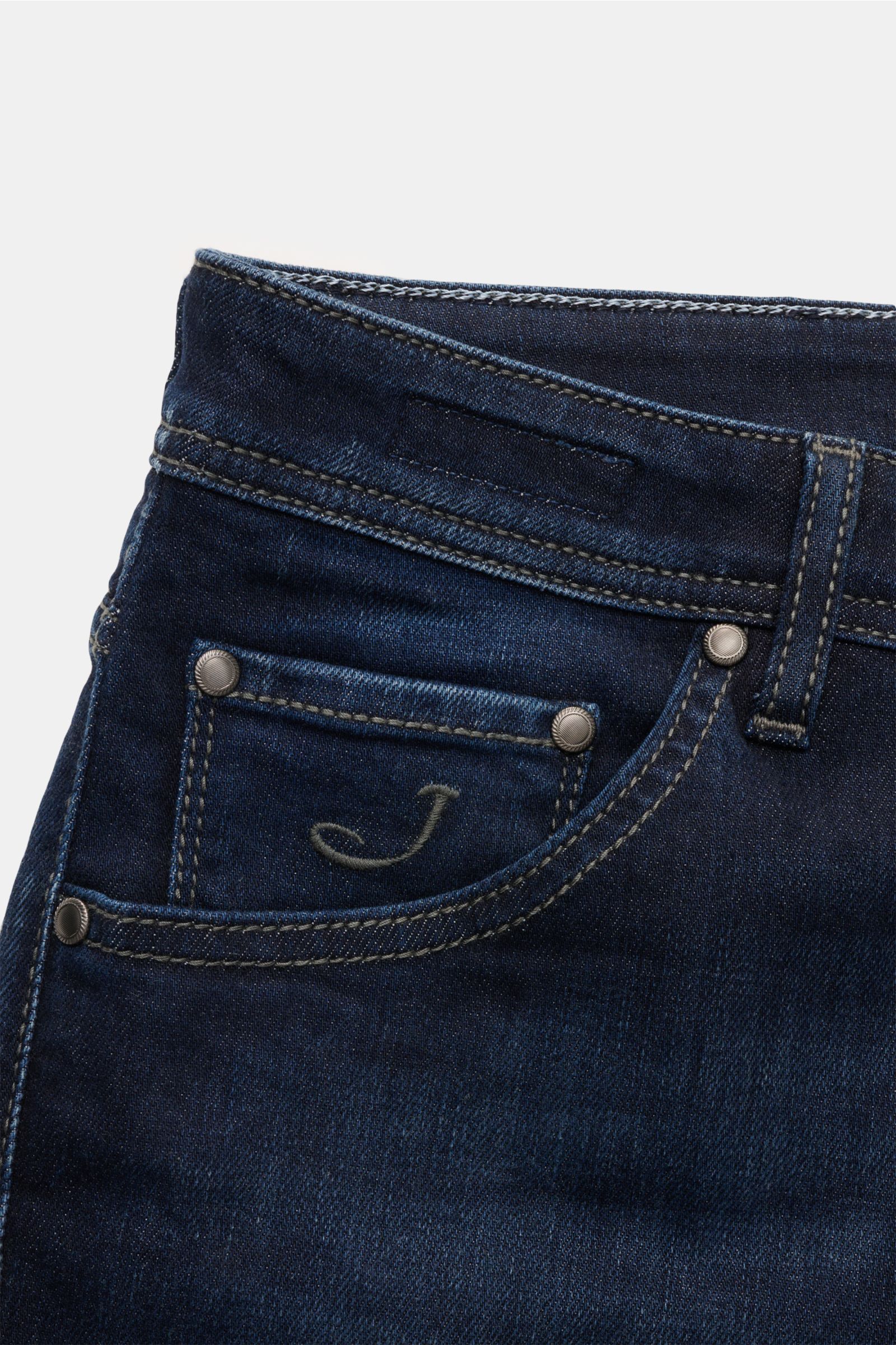 Close-up front view of Jacob Cohen Jeans 'Scott' navy made of cotton, lyocell, microfiber denim with elastic, soft touch, subtle used wash, slim fit, ankle length, very tapered, button fly, five-pocket style, coin pocket with initial, back pockets with st
