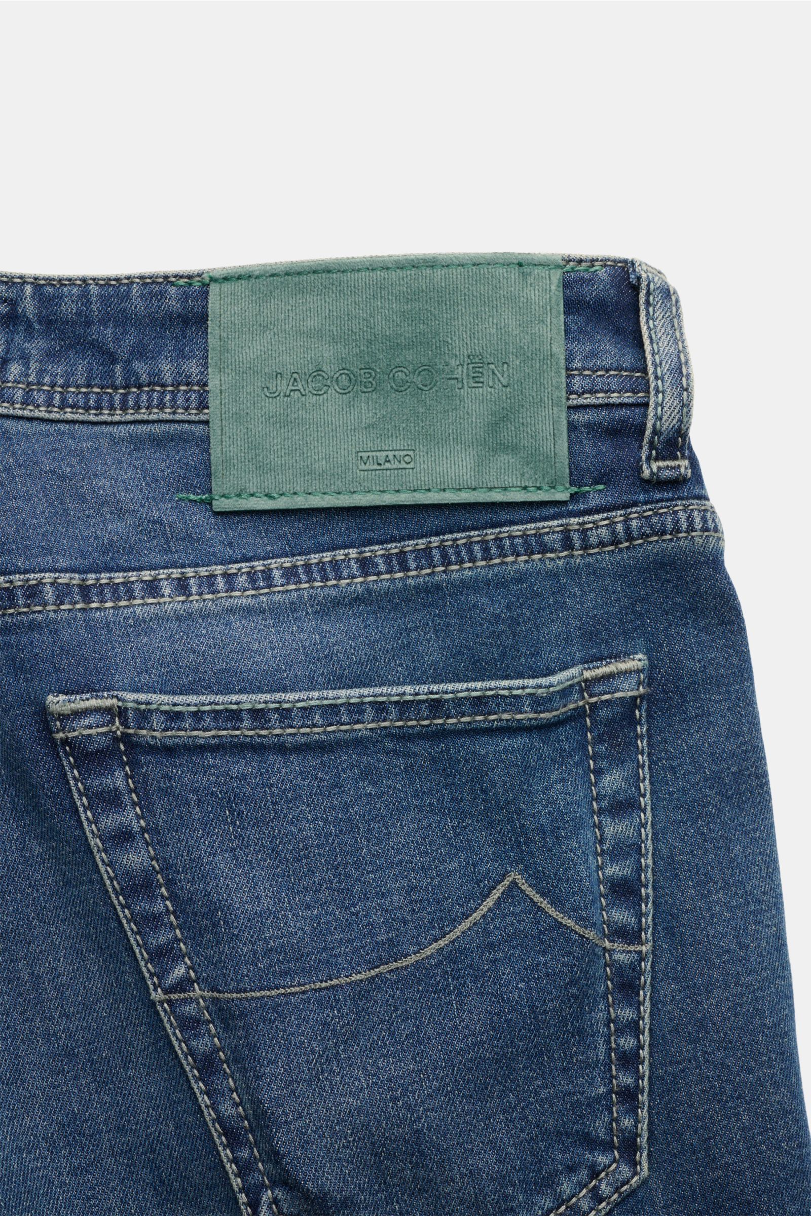 Close-up rear view of Jacob Cohen Jeans 'Scott' graublau showing denim cotton-lyocell fabric, elastic quality, soft touch, subtle used wash, slim fit, high waist, ankle length, very tapered, button fly, five-pocket style, coin pocket with initial, stitche