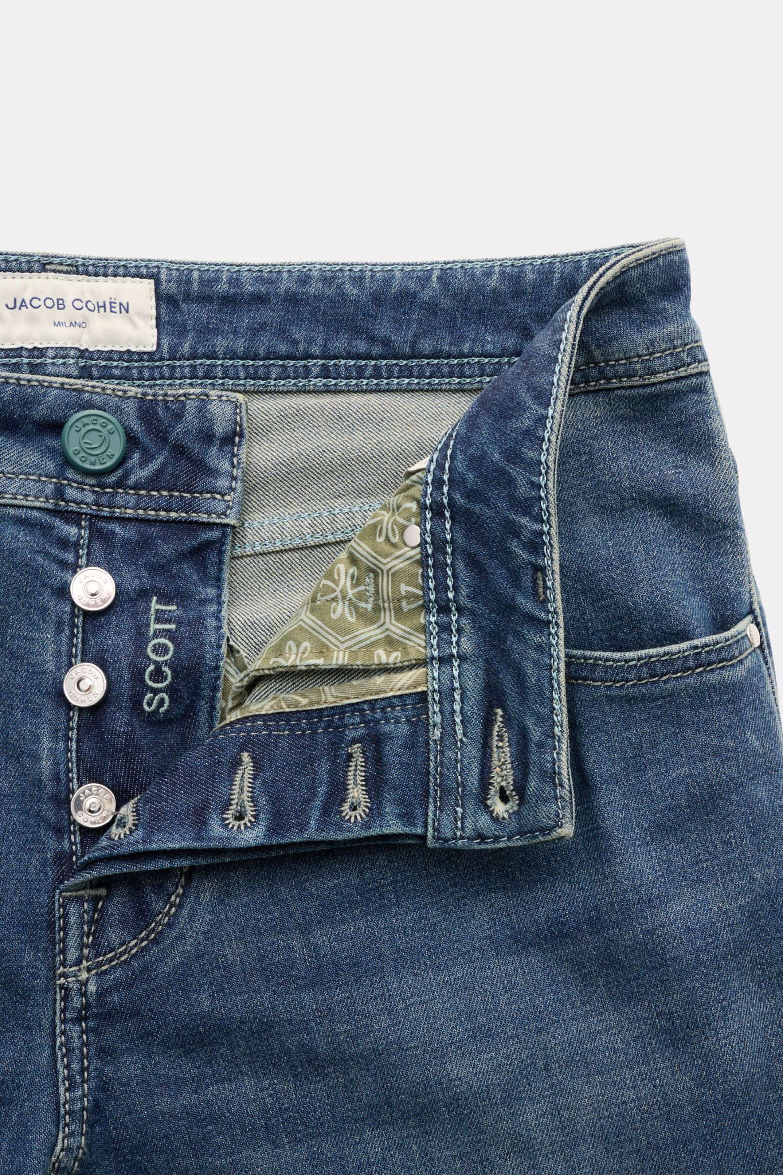 Close-up front view of Jacob Cohen Jeans 'Scott' graublau, showing button fly, denim made from cotton and lyocell, elastic quality, soft feel, subtle used wash, slim fit, high waist, ankle length, very tapered, five-pocket style with coin pocket featuring