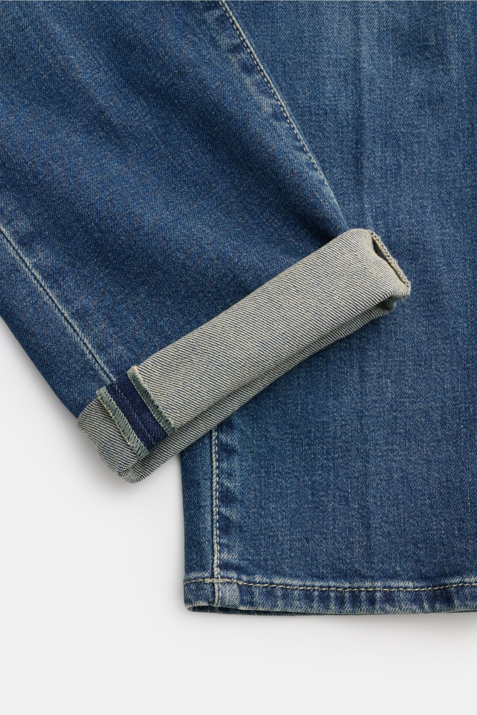 Close-up view of the lower leg and cuff of Jacob Cohen Jeans 'Scott' graublau, showing denim aus Baumwolle und Lyocell, elastische Qualität, softer Griff, dezente Used-Waschung, Slim Fit, hohe Bundhöhe, knöchellang, sehr schmal zulaufend, Button Fly, Five