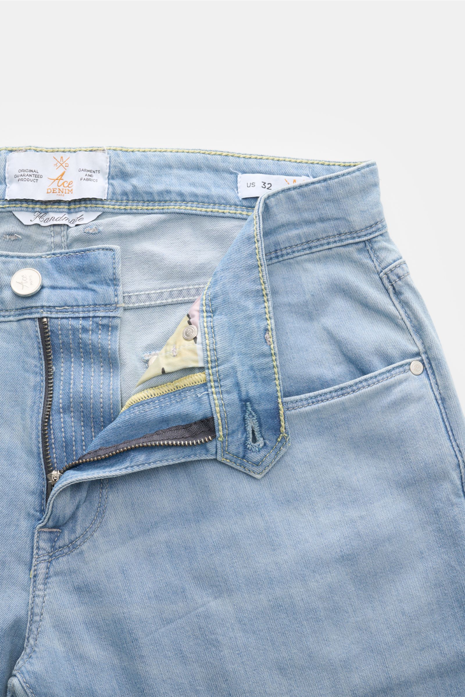 Close-up front view of Ace Denim Jeans 'AD 15 bleached' light blue with button fly, five-pocket style, and woven patch.

Description: ACE DENIM stands for hand-made jeans and sustainable production processes – the model 'AD 15' is made of a material bl