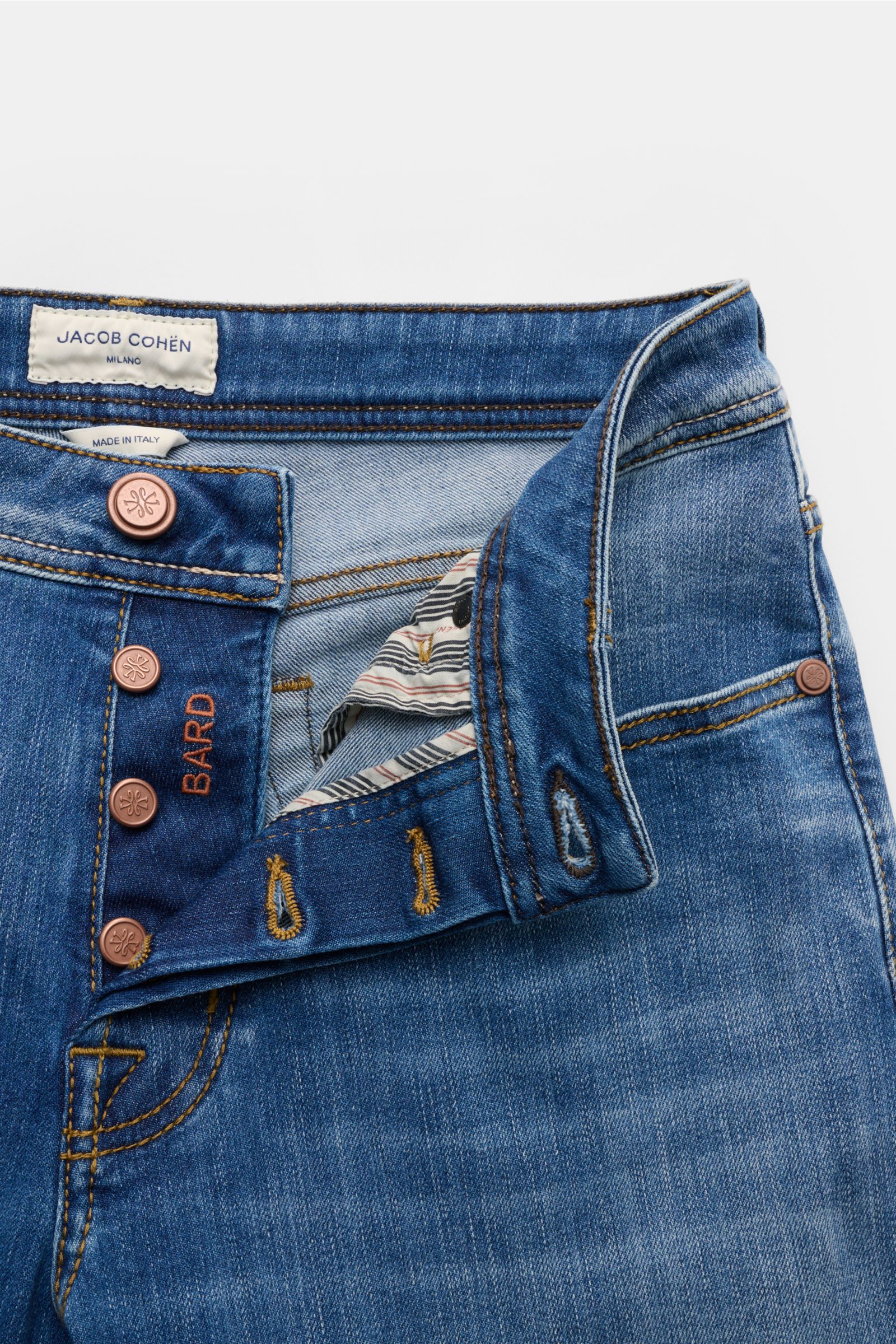 Close-up front view of Jacob Cohen Jeans 'Bard' blau with open button fly, visible BARD embroidery, stitching, and label detailing.  
Moderner Luxus für jeden Tag: Die Premium-Jeans 'Bard' von JACOB COHEN vereint ikonischen Stil mit hohem Tragekomfort.