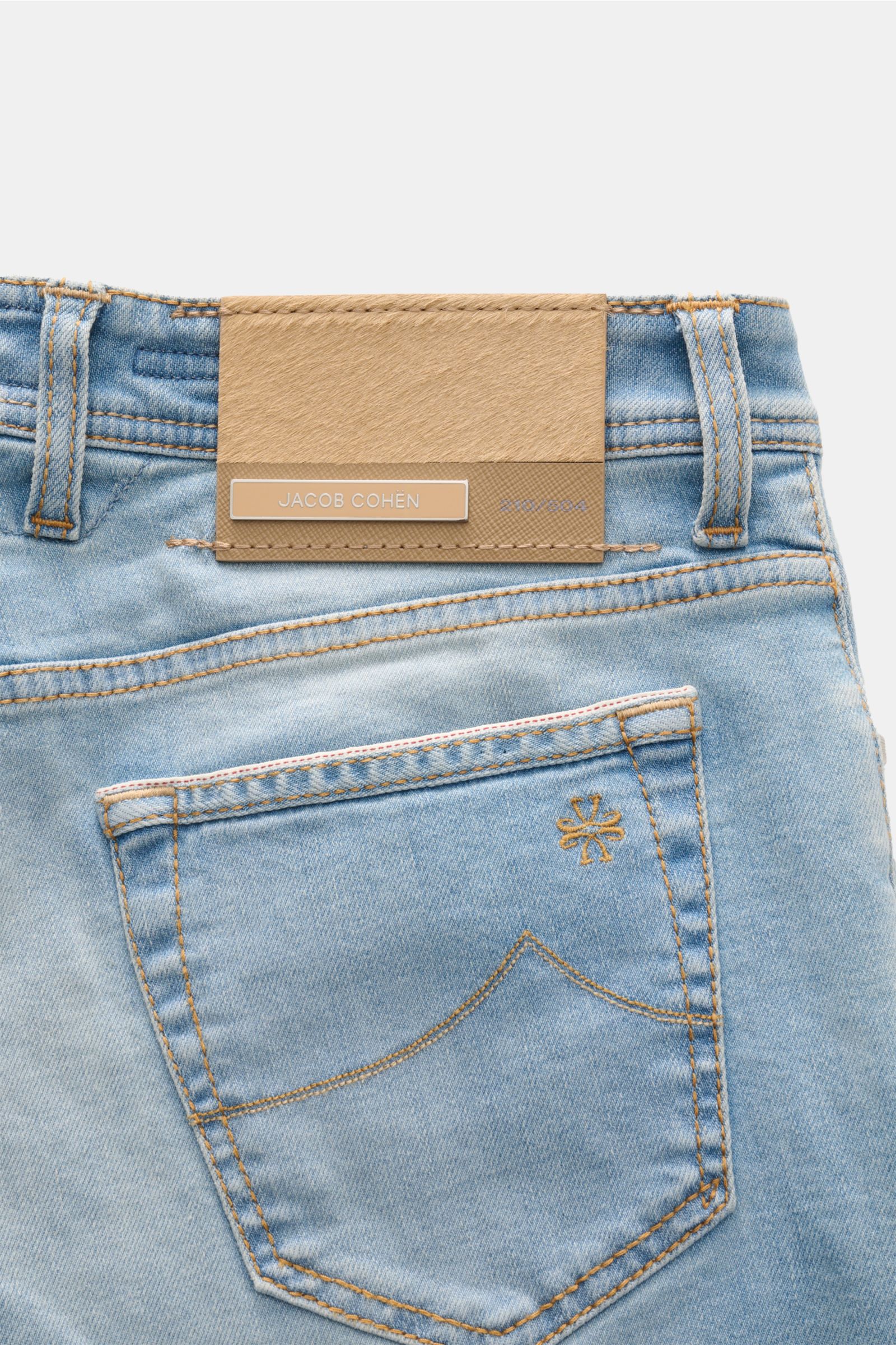 Close-up rear view of Jacob Cohen Jeans 'Bard LTD' rauchblau showing the light blue denim with subtle used wash, contrast stitching, back pocket with signature stitch, and distinctive beige calf leather patch with brand name and limited edition embossing.