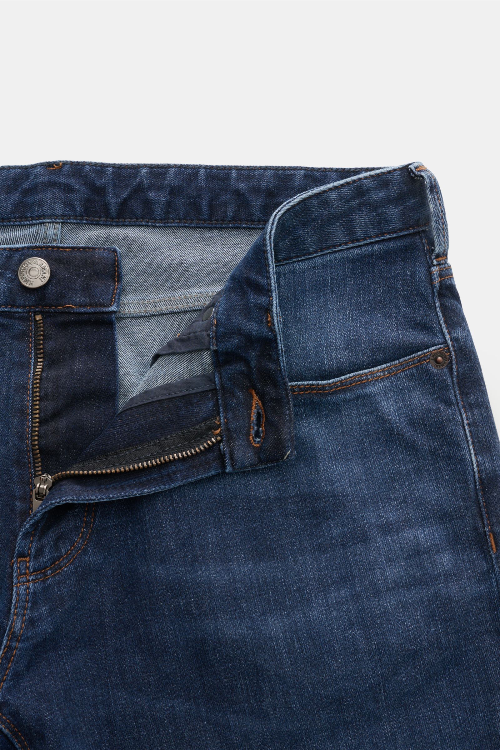 Close-up front view of Emporio Armani Jeans dark blue with open zip fly, showcasing authentic wash and metal logo button.

Description: Comfort meets style: These jeans by EMPORIO ARMANI have a comfortable feel and a timeless aesthetic for modern casua
