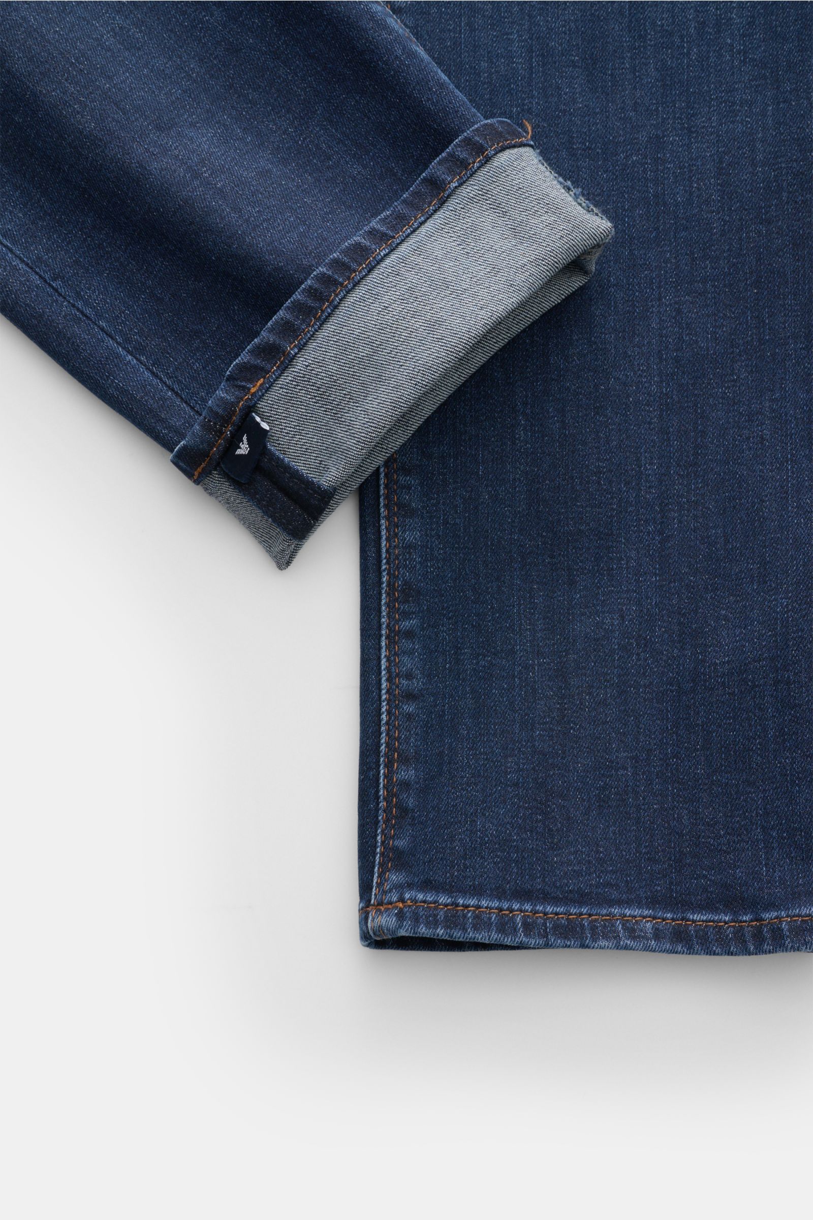 Close-up front view of Emporio Armani Jeans dark blue showing cuff detail with folded hem and visible label.

Comfort meets style: These jeans by EMPORIO ARMANI have a comfortable feel and a timeless aesthetic for modern casual looks.

Stre