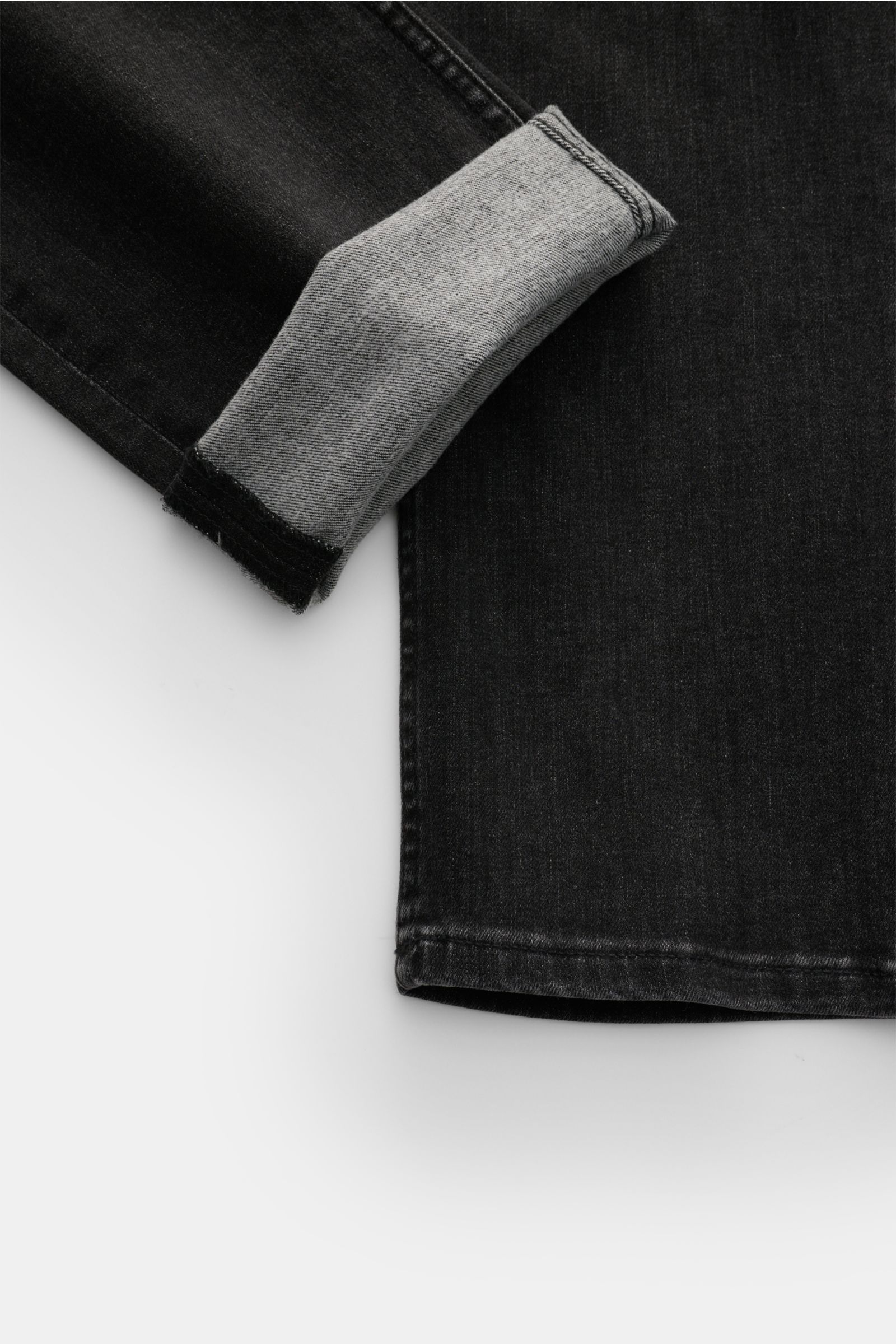 Close-up view of the cuff and lower leg of 7 for all mankind Jeans 'Slimmy' dark grey in a subtle used wash with slight stretch.

Description: Seven pairs of jeans should be enough to get you through life – that’s the philosophy of denim label 7 FOR AL