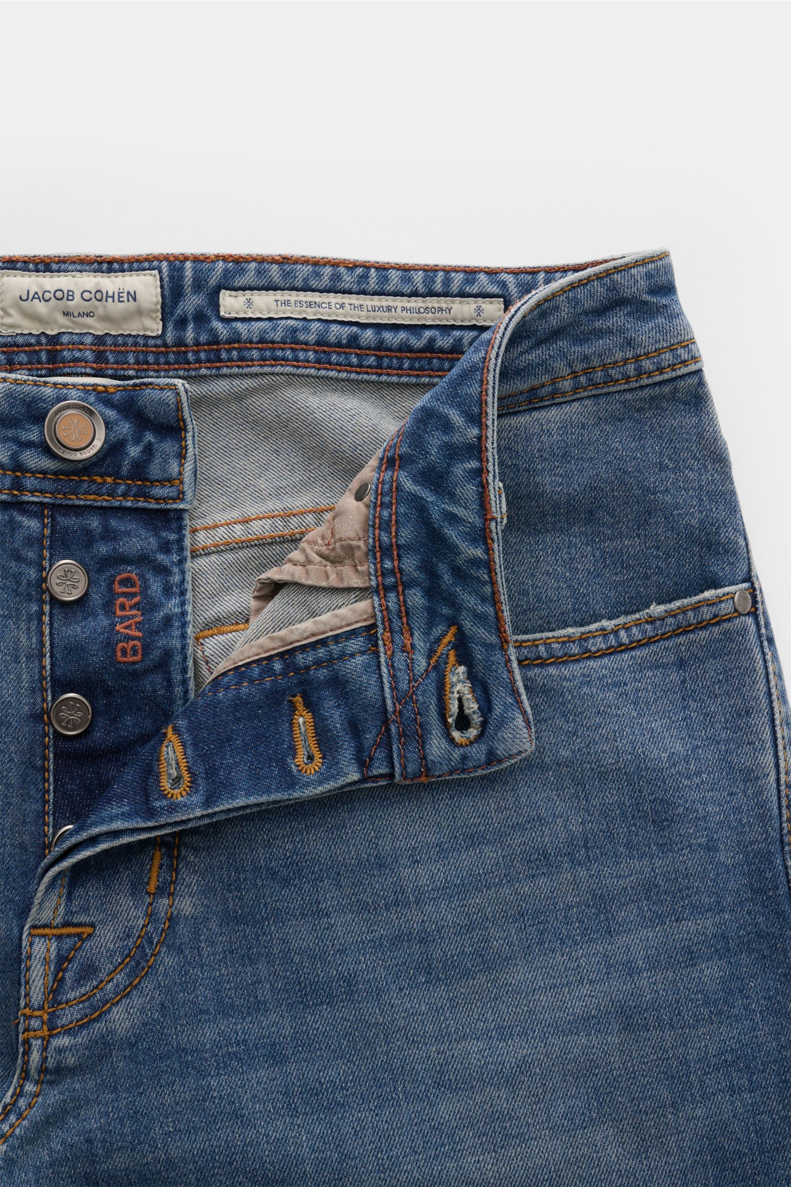 Jacob Cohen Jeans 'Bard' smoky blue shown from a top front close-up with open button fly, visible stitching, and branded labels.