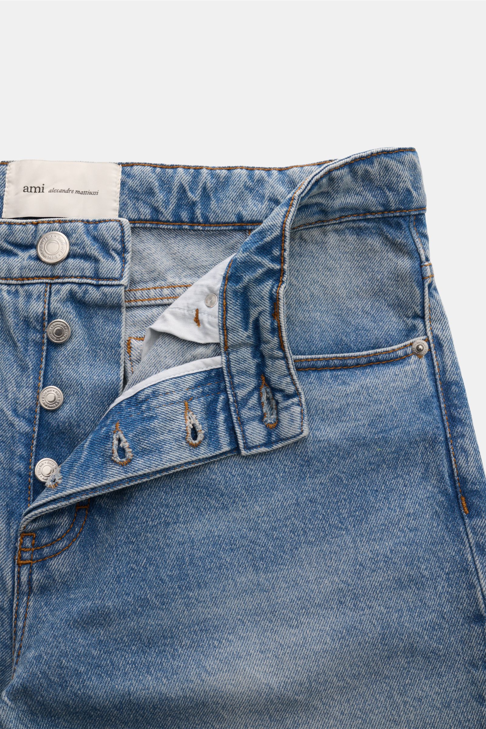 Close-up front view of Ami Paris Jeans 'Classic Fit' smoky blue denim, showing button fly, belt loops, and front pocket details.

Description: Casual denim by Parisian label AMI PARIS: The model 'Classic Fit' in pure cotton denim is perfect for classic