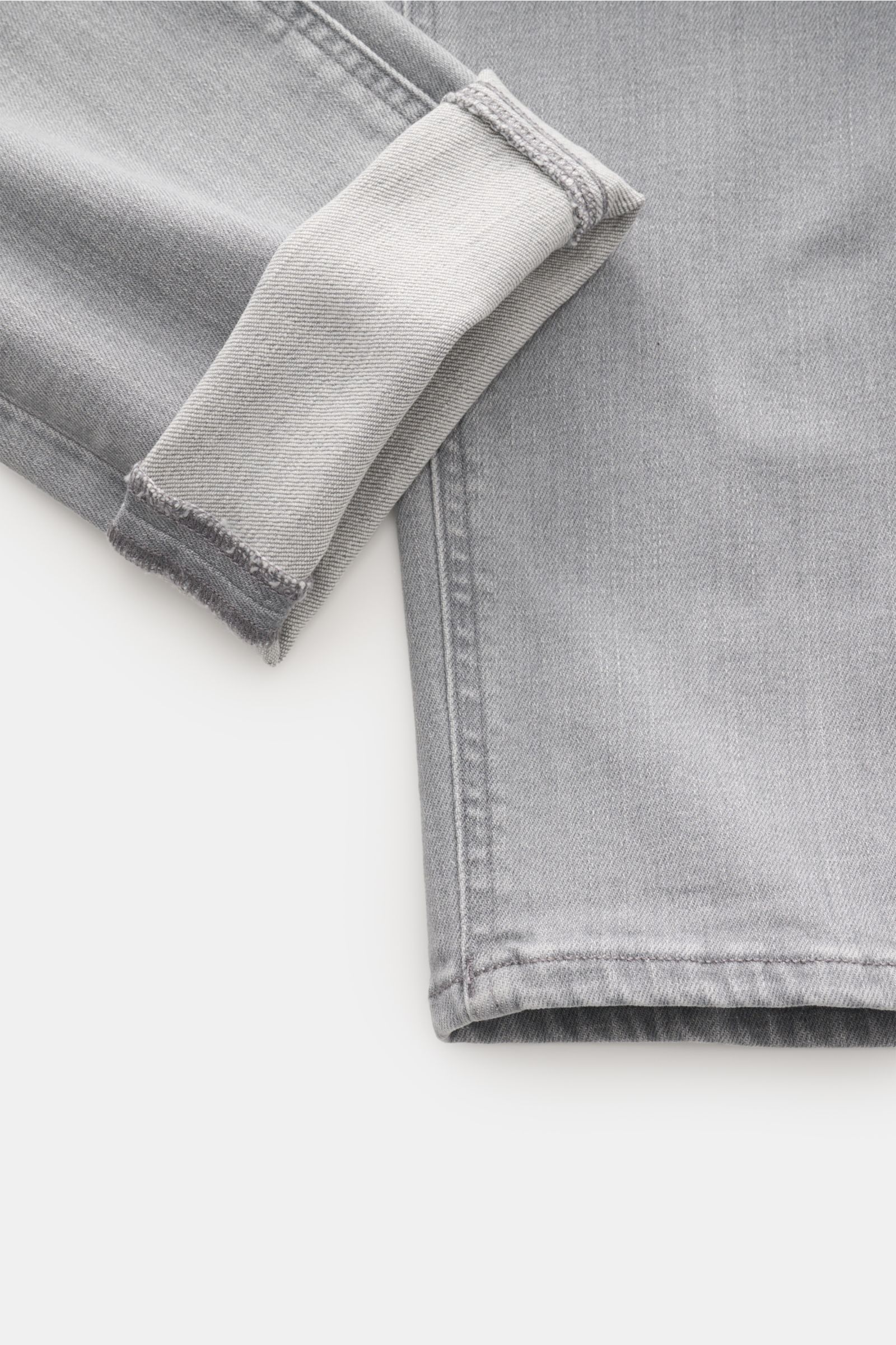 Close-up image of the lower leg and cuff of Dondup Jeans 'George' grey, showing stretchy cotton denim with authentic used wash, soft feel, and folded hem from a top-down perspective. Comfortable denim: The jeans 'George' in stretchy cotton by DONDUP are v