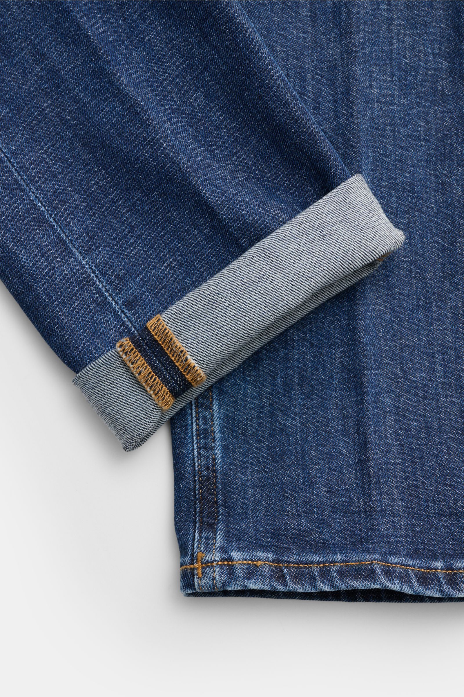 Dondup Jeans 'George' dunkelblau, Detailaufnahme vom Bein mit umgeschlagenem Saum, elastischer Baumwolle, Used-Waschung, Skinny Fit.