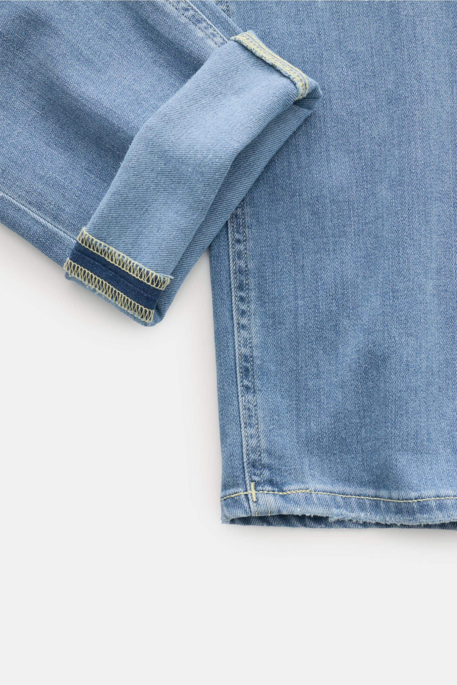 Close-up front view of Dondup Jeans 'George' rauchblau showing the cuff and lower leg with elastic cotton denim, soft feel, authentic used wash, skinny fit, and detailed stitching.