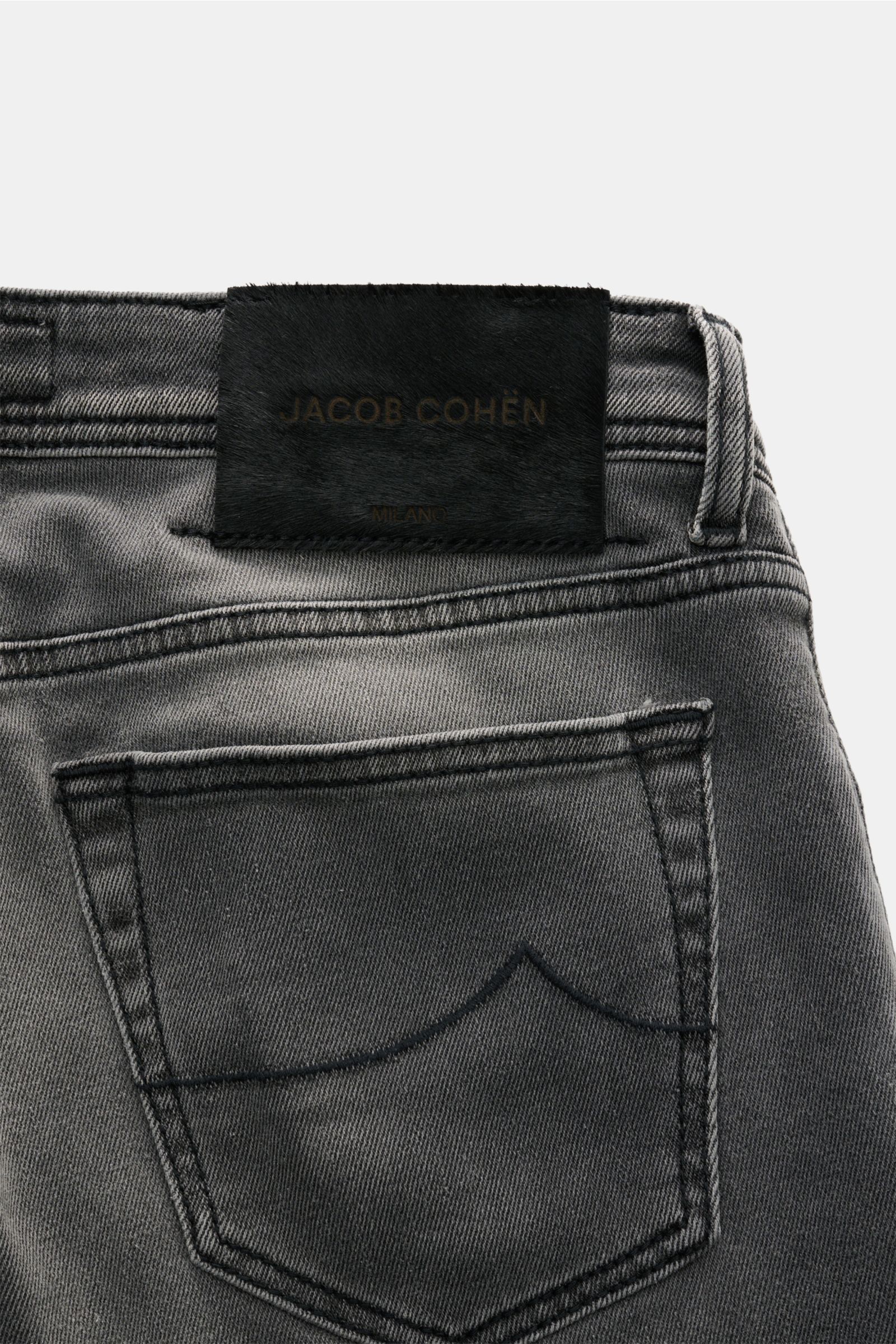 Close-up rear view of Jacob Cohen Jeans 'Nick' grey, showcasing subtle used wash, back pocket with stitching, leather patch in pony skin look. Denim made of cotton and microfibre, elasticated fabric, soft feel, slim fit, tapered cut, button fly, five-pock