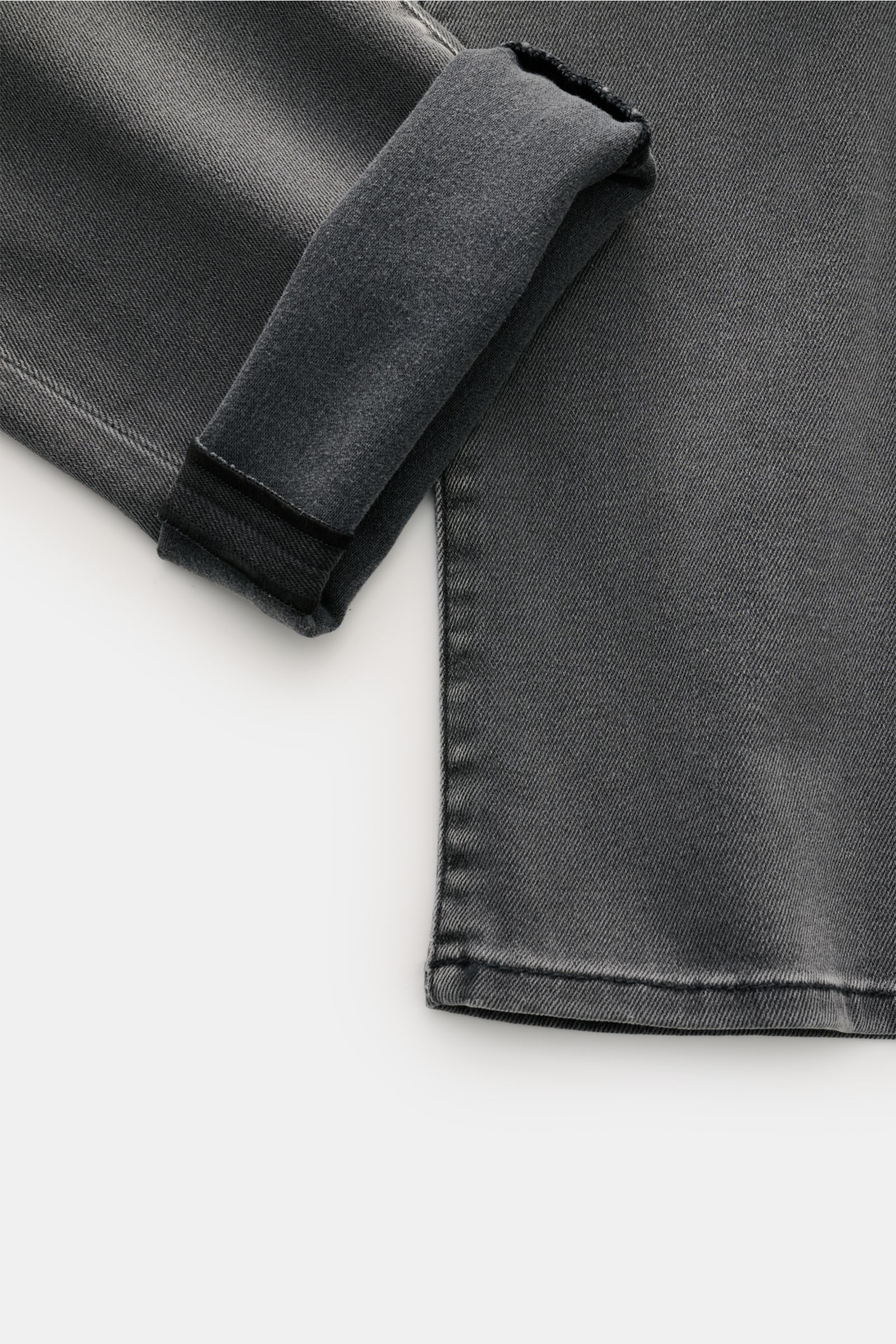 Jacob Cohen Jeans 'Nick' grey shown from a close-up side angle, featuring denim made of cotton and microfibre, elasticated fabric, soft feel, subtle used wash, slim fit, tapered cut, button fly, five-pocket style, coin pocket with initial, back pockets wi