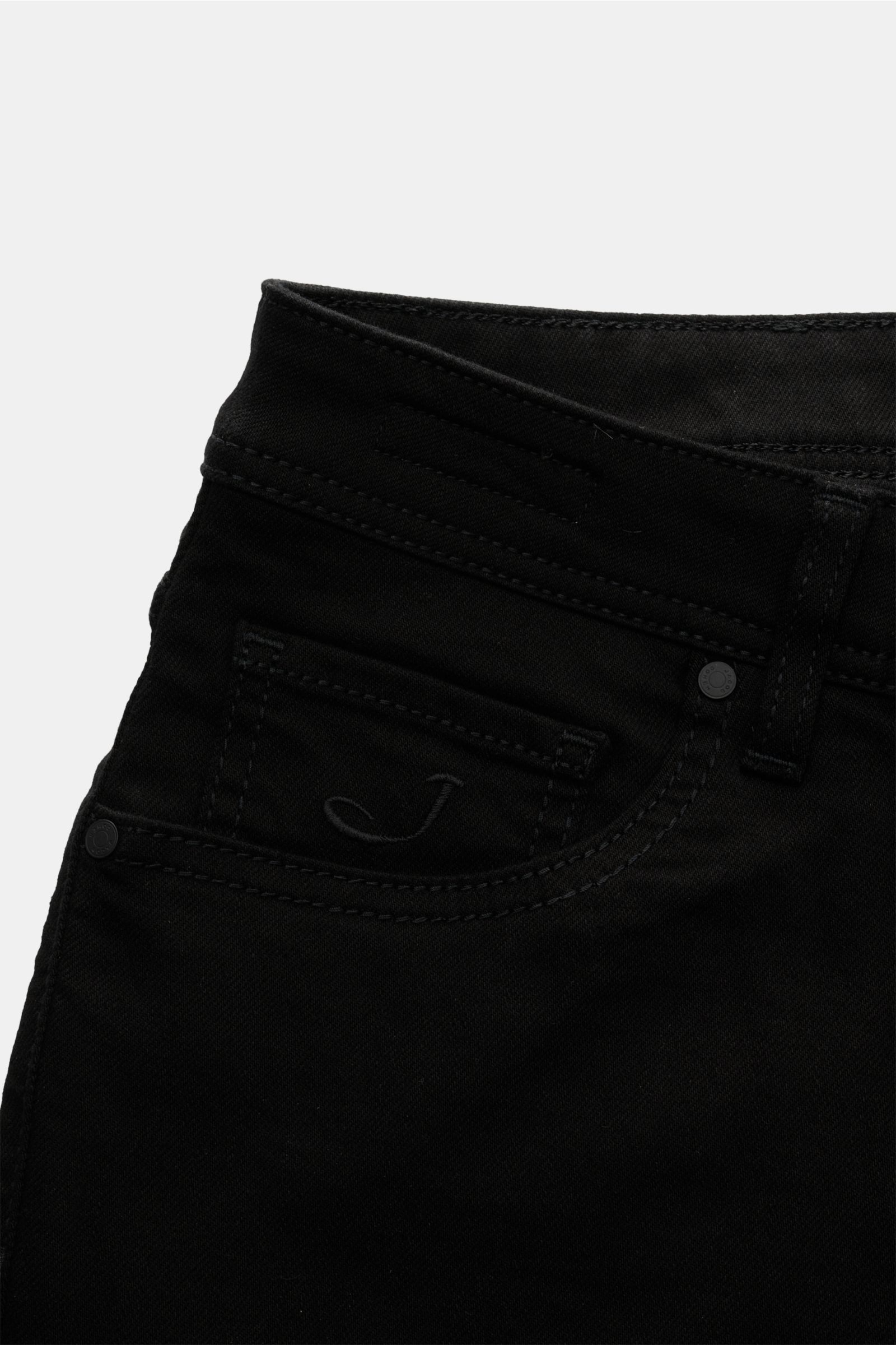 Close-up front view of Jacob Cohen Jeans 'Nick' black showing denim made of cotton and microfibre, elasticated fabric, soft feel, slim fit, tapered cut, button fly, five-pocket style including coin pocket with initial, back pockets with stitching, and lea