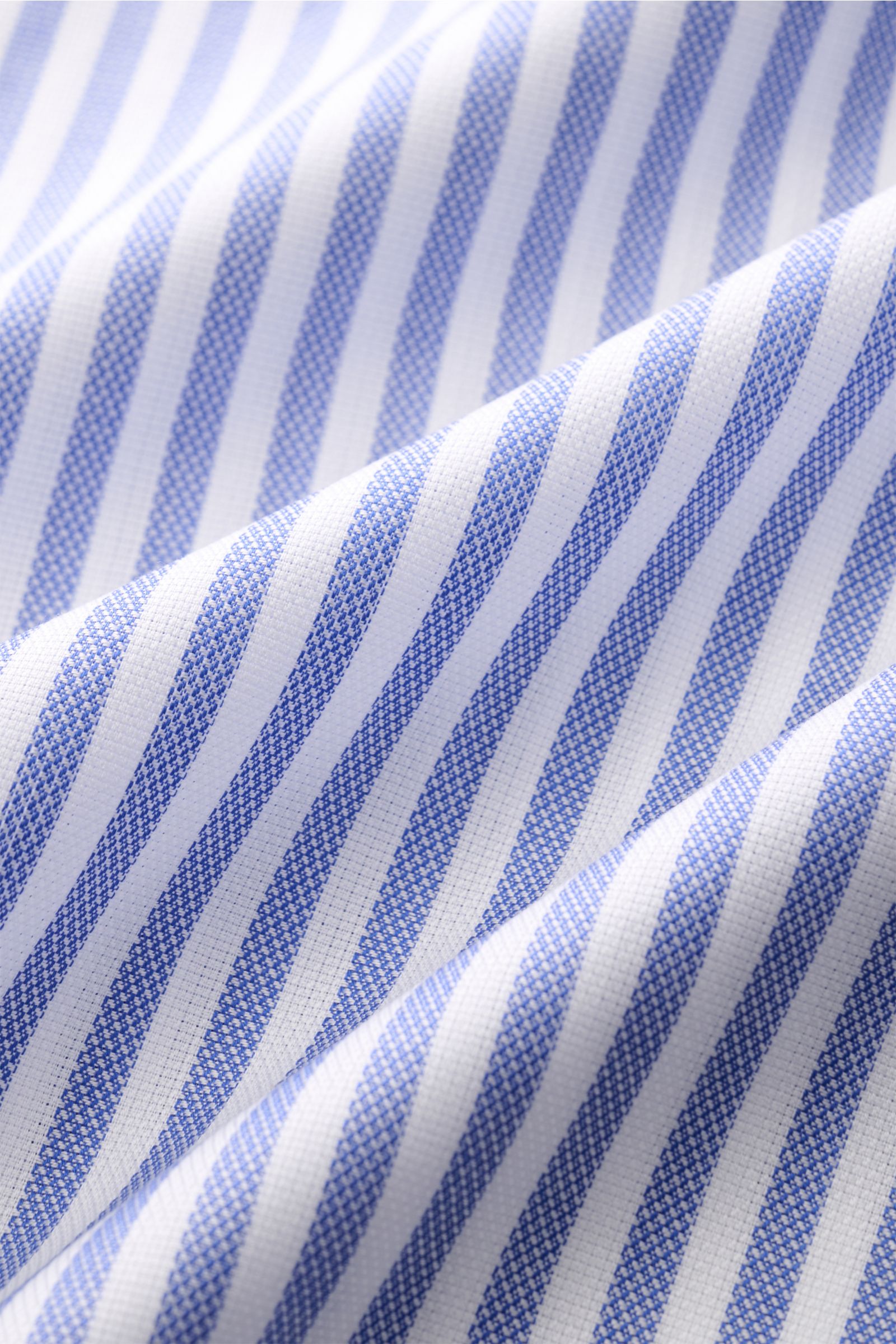 Close-up front view of fabric texture of Finamore Business shirt 'Sergio Napoli' shark collar dark blue/white striped, pure cotton, soft smooth feel, slim fit, extra-long sleeves, shark collar, French button placket, classic barrel cuffs, rounded hem.