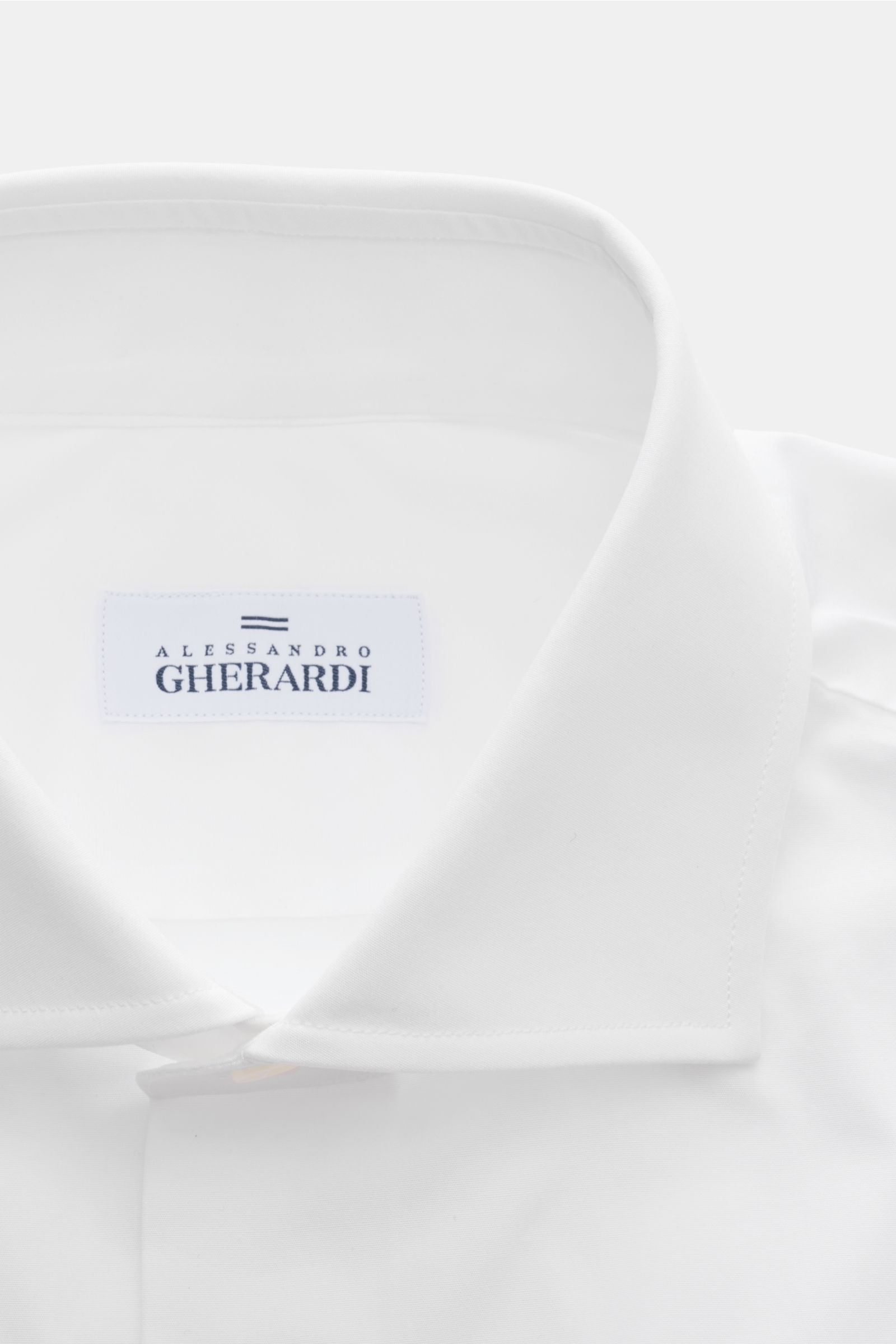 Close-up front view of Gherardi Business shirt shark collar white showing the shark collar and label.

Description: This elegant business shirt with barrel cuffs by GHERARDI is made of the finest, premium quality cotton that combines with an extra slim