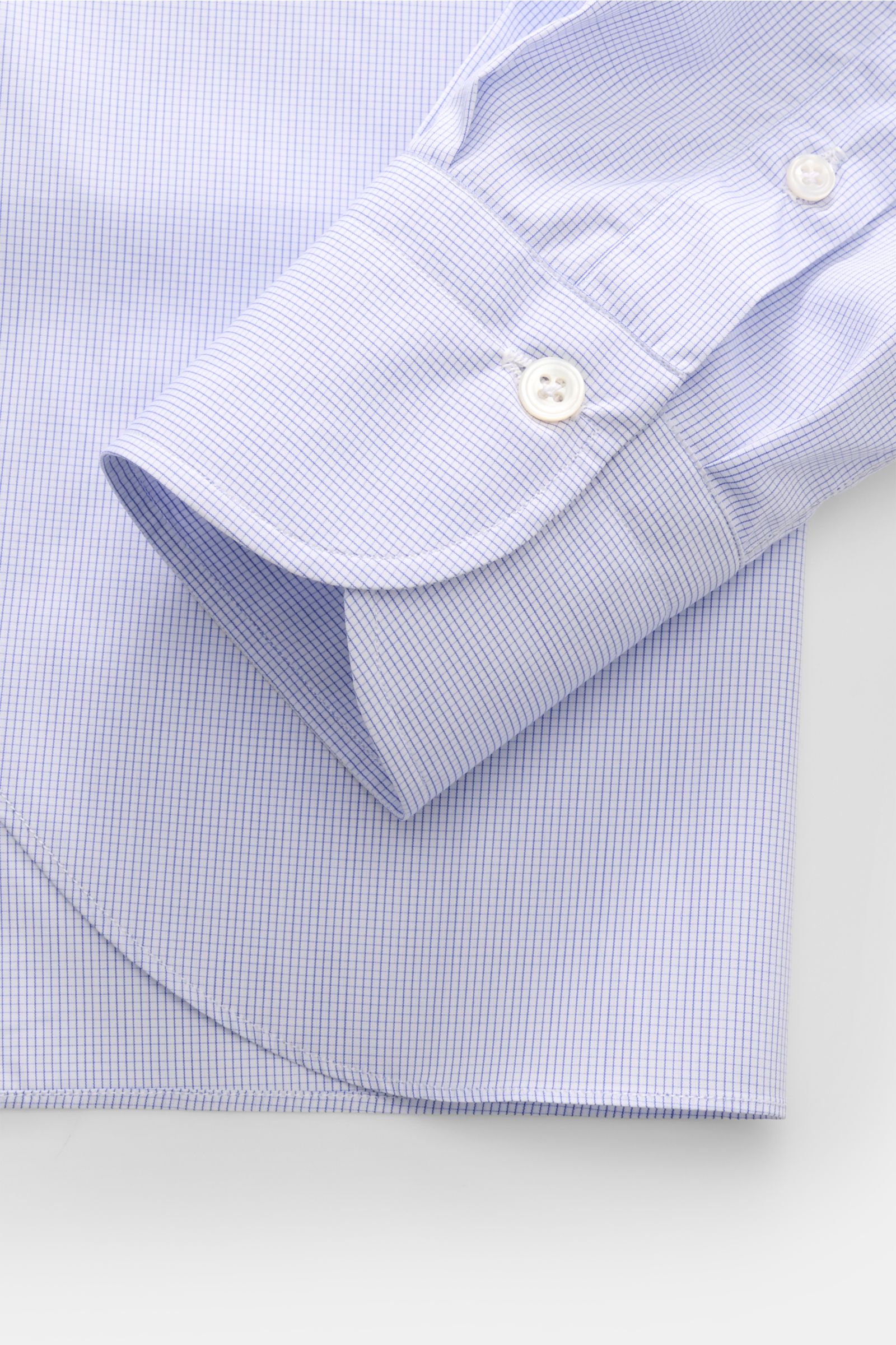 Close-up view of Finamore Business shirt 'Sergio Milano' shark collar blue/white checked cuff and sleeve, showing micro checked pattern, French button placket, and classic barrel cuffs in pure Giza cotton with soft touch and extra slim fit. Effortlessl