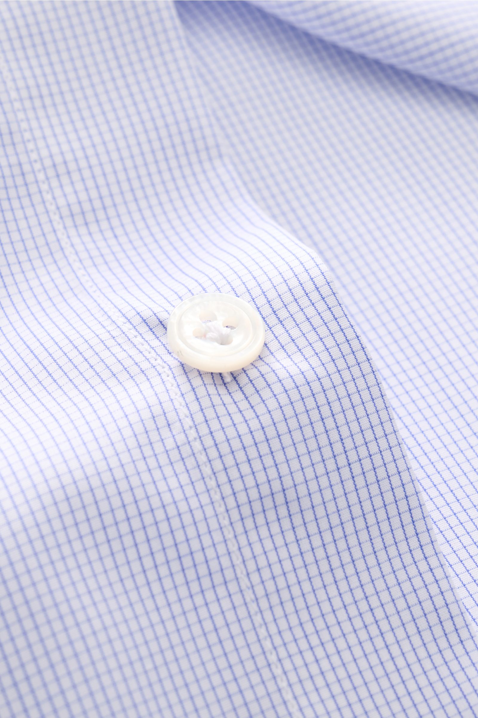 Close-up front view of Finamore Business shirt 'Sergio Milano' shark collar blue/white checked showing micro checked pattern and button detail. Effortlessly create a range of stylish business outfits with the shirt 'Sergio Milano' from the 170 a due li