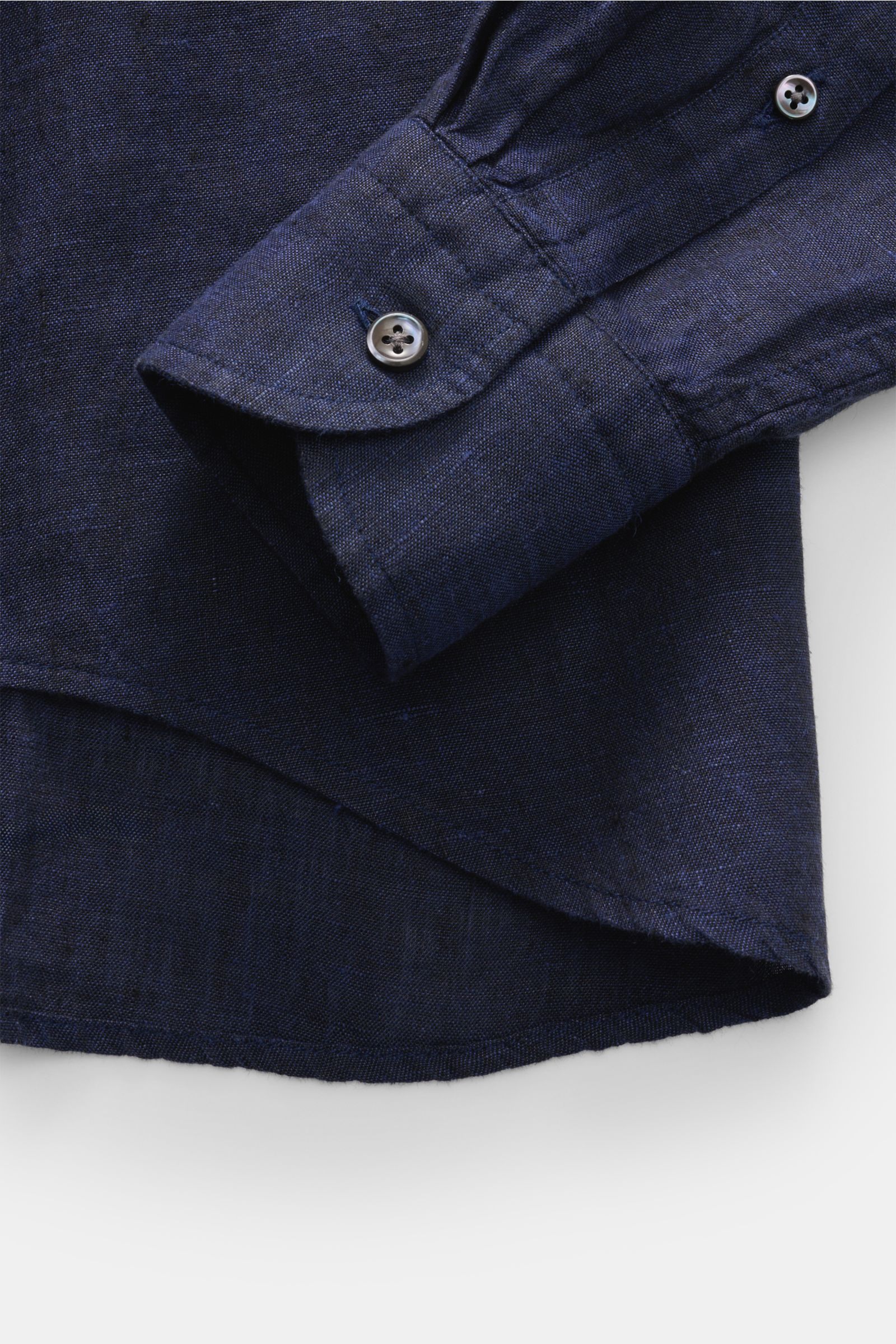Close-up front view of the navy von Braun Leinenhemd Haifisch-Kragen showcasing the cuff, button, and linen texture with rounded hem. Mühelose Leichtigkeit