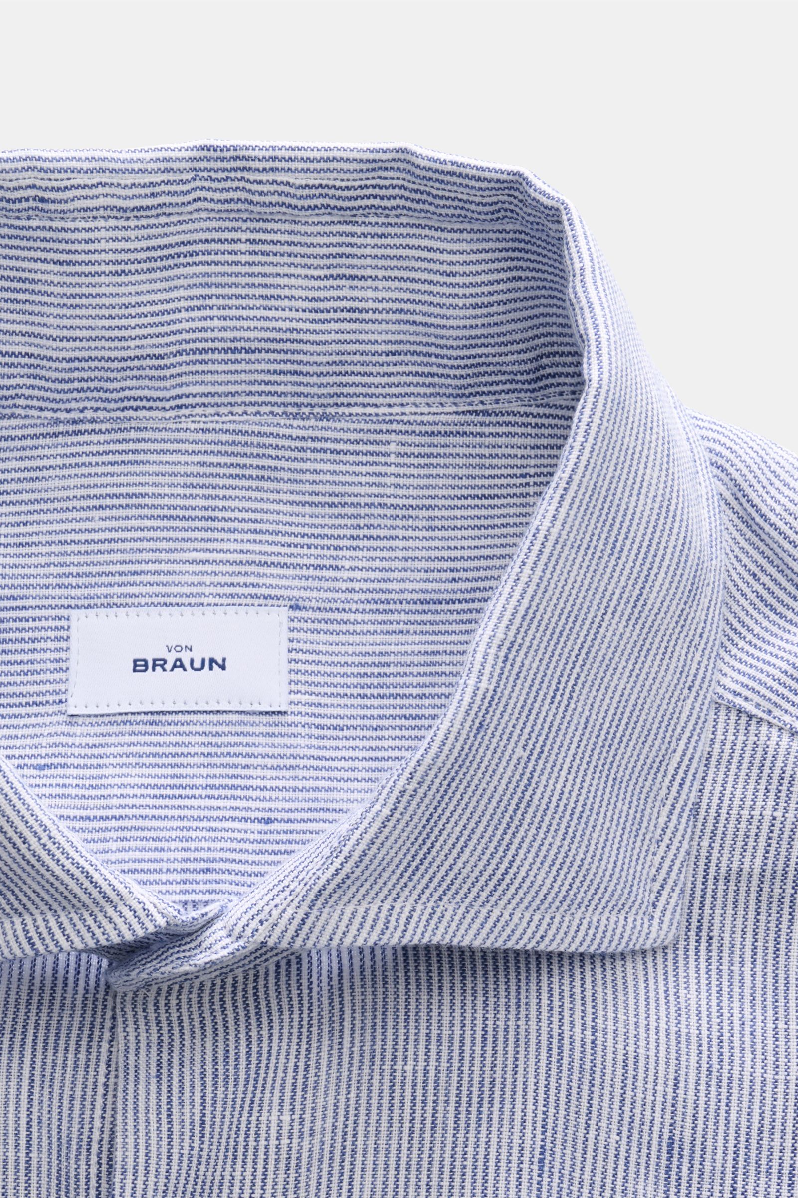Close-up view of the collar and label of the von Braun Leinenhemd Haifisch-Kragen navy/weiß gestreift, made of pure linen with fine navy and white stripes. Mühelose&nbsp;Leichtigkeit