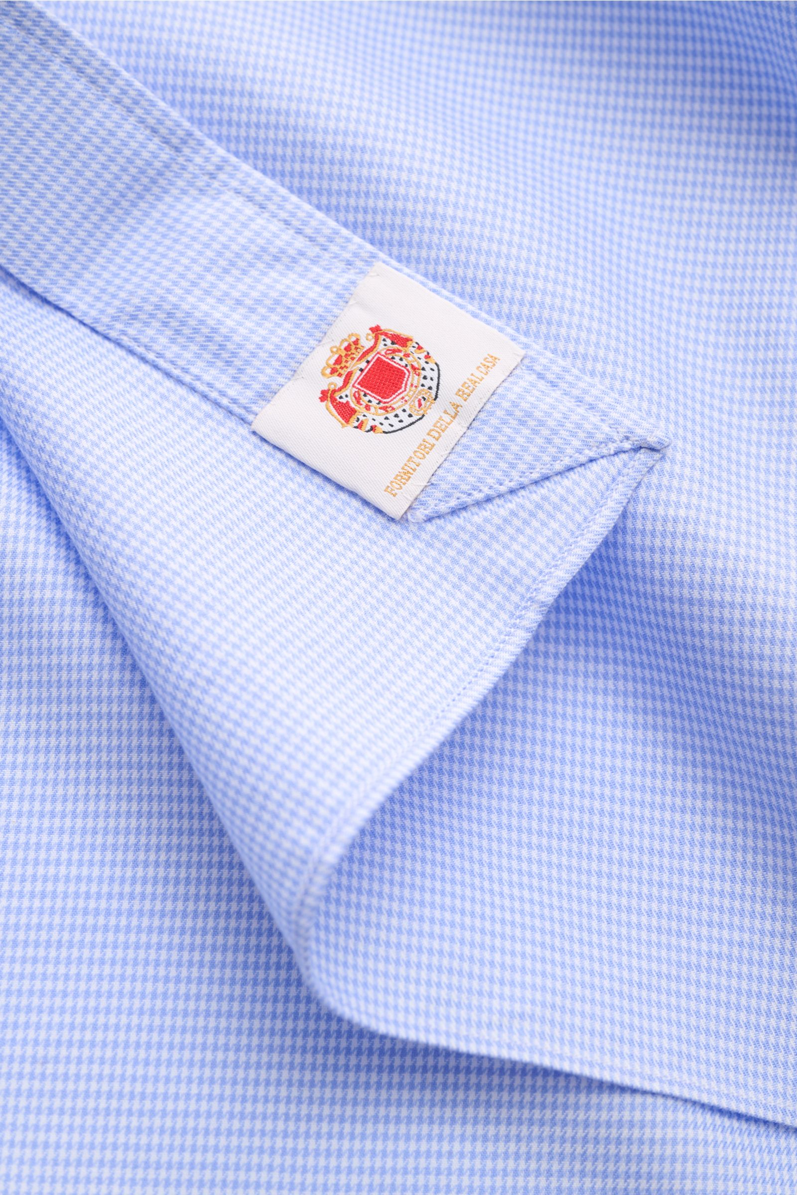 Close-up front view of Borrelli Casual shirt 'Ettore' shark collar blue/white checked, showing pure cotton twill fabric with smooth feel, micro houndstooth pattern, French button placket with mother-of-pearl buttons, classic barrel cuffs, and rounded hem.