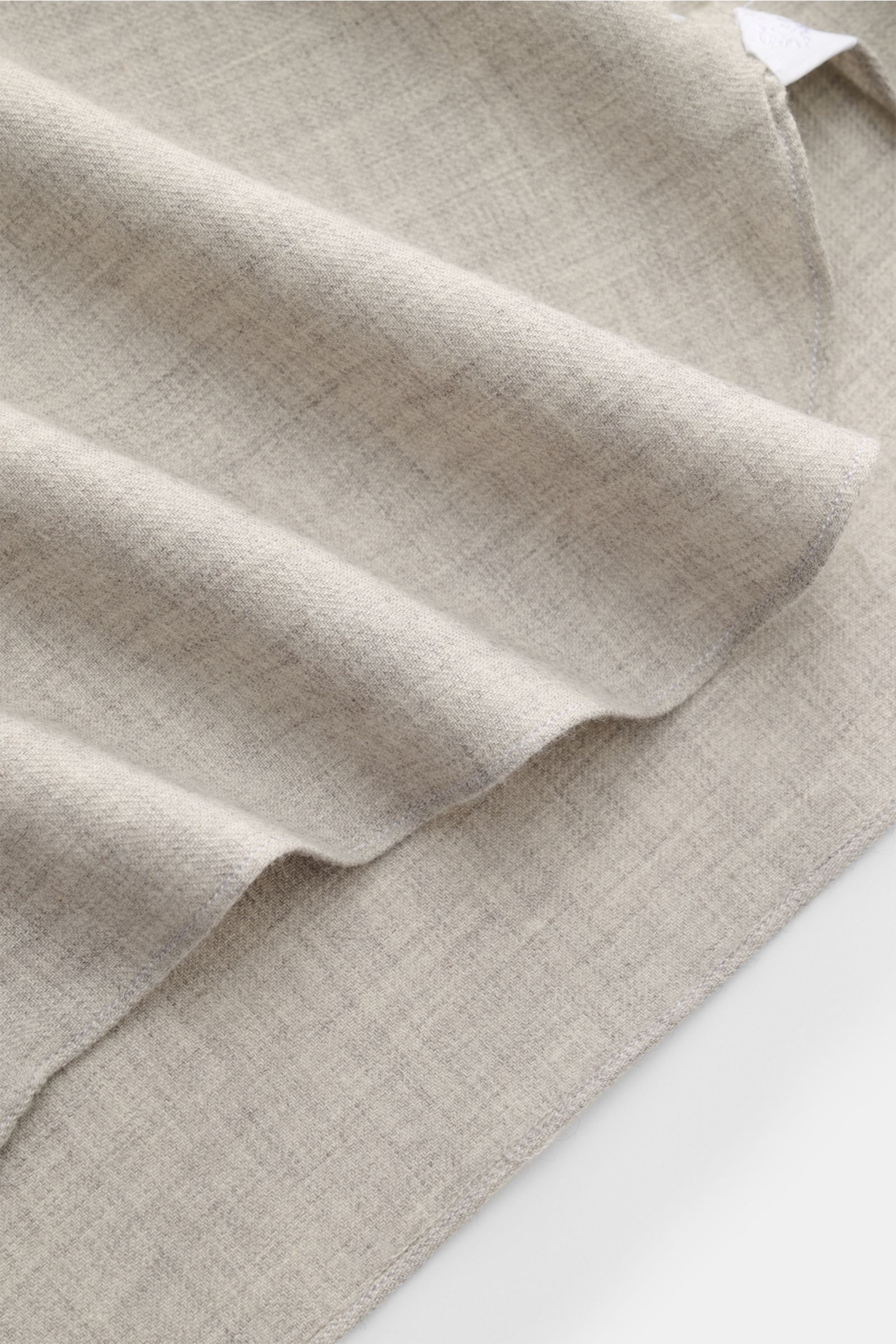 Close-up image of the Borrelli Flannel shirt 'Ettore' shark collar grey mottled fabric, showing twill in cotton and wool, brushed with a smooth feel, photographed from above highlighting the texture and rounded hem. Features slim fit, French button placke