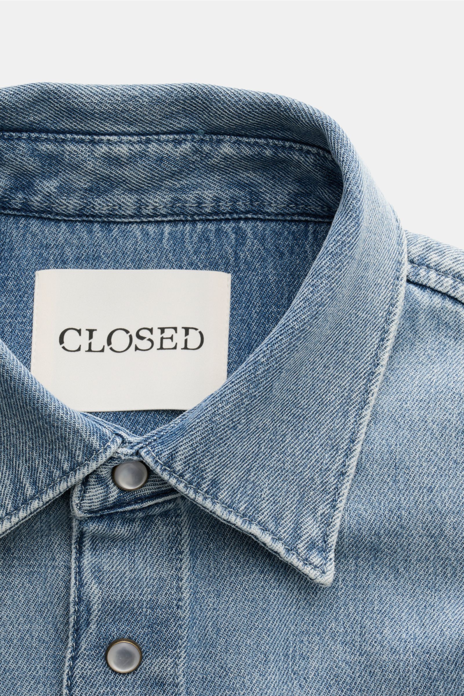 Closed Jeanshemd Kent-Kragen rauchblau, Detailaufnahme von oben, reine Baumwolle, Perlmutt-Druckknöpfe, Regular Fit, aufgesetzte Brusttaschen, tonale Logo-Stickerei.