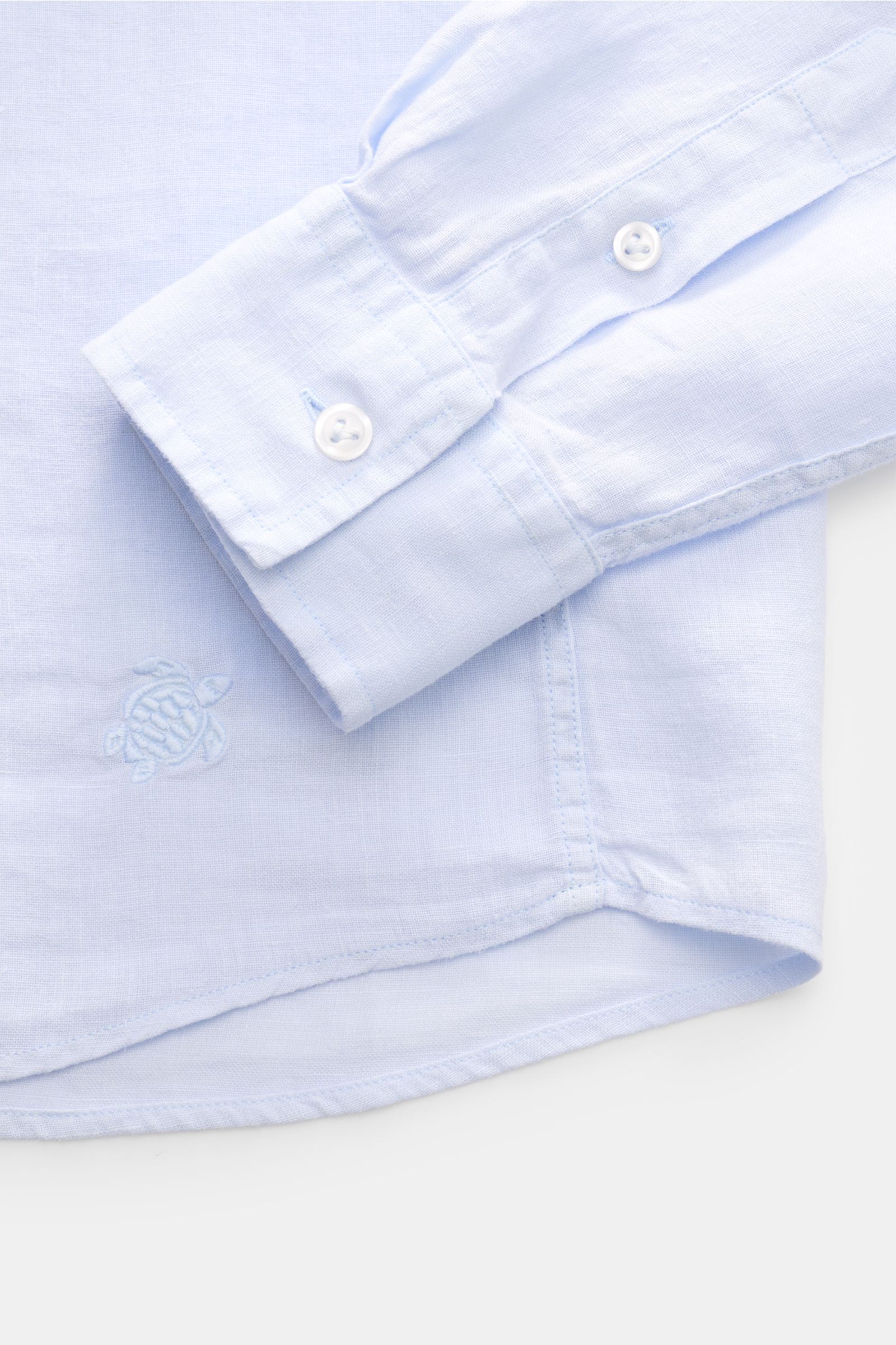 Nahaufnahme von Vilebrequin Leinenhemd schmaler Kragen pastellblau, reine Leinenqualität, luftige Leinwandbindung, weicher Griff, Regular Fit, französische Knopfleiste, klassische Sportmanschette, aufgesetzte Brusttasche, gerundeter Saum mit tonalem Stitc