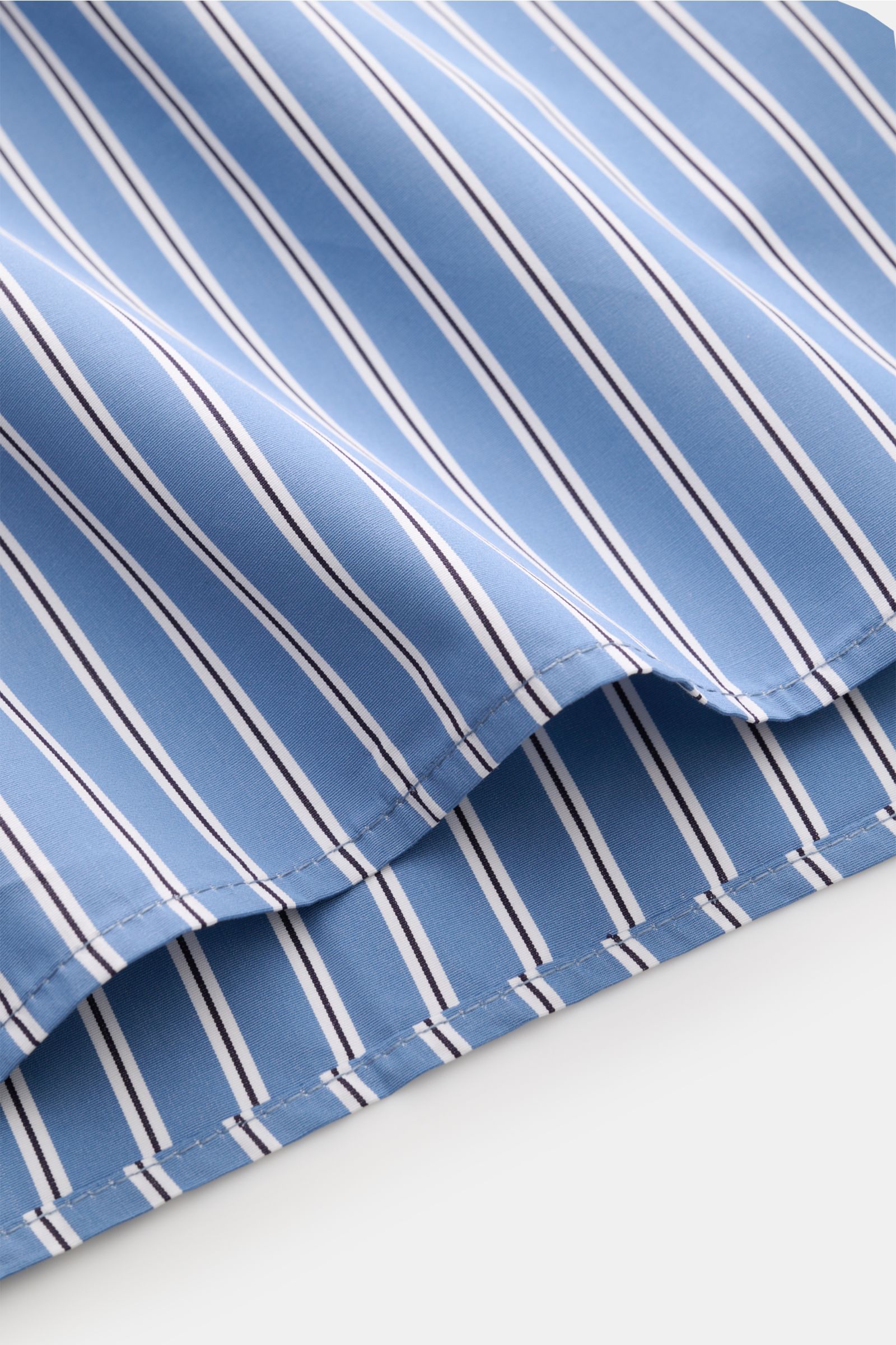 Ausschnitt des A.P.C. Casual Hemds Kent-Kragen graublau/schwarz/weiß gestreift in Oversized Fit, reine Baumwolle mit gerundetem Saum, Nahaufnahme.