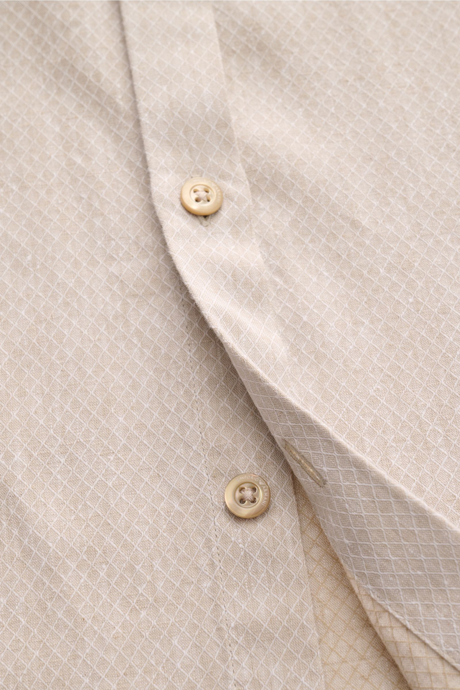 Emporio Armani Casual Hemd Grandad-Kragen sand, Nahaufnahme schräg von oben, feines Strukturgewebe aus Leinen-Baumwolle, Knopfleiste sichtbar.