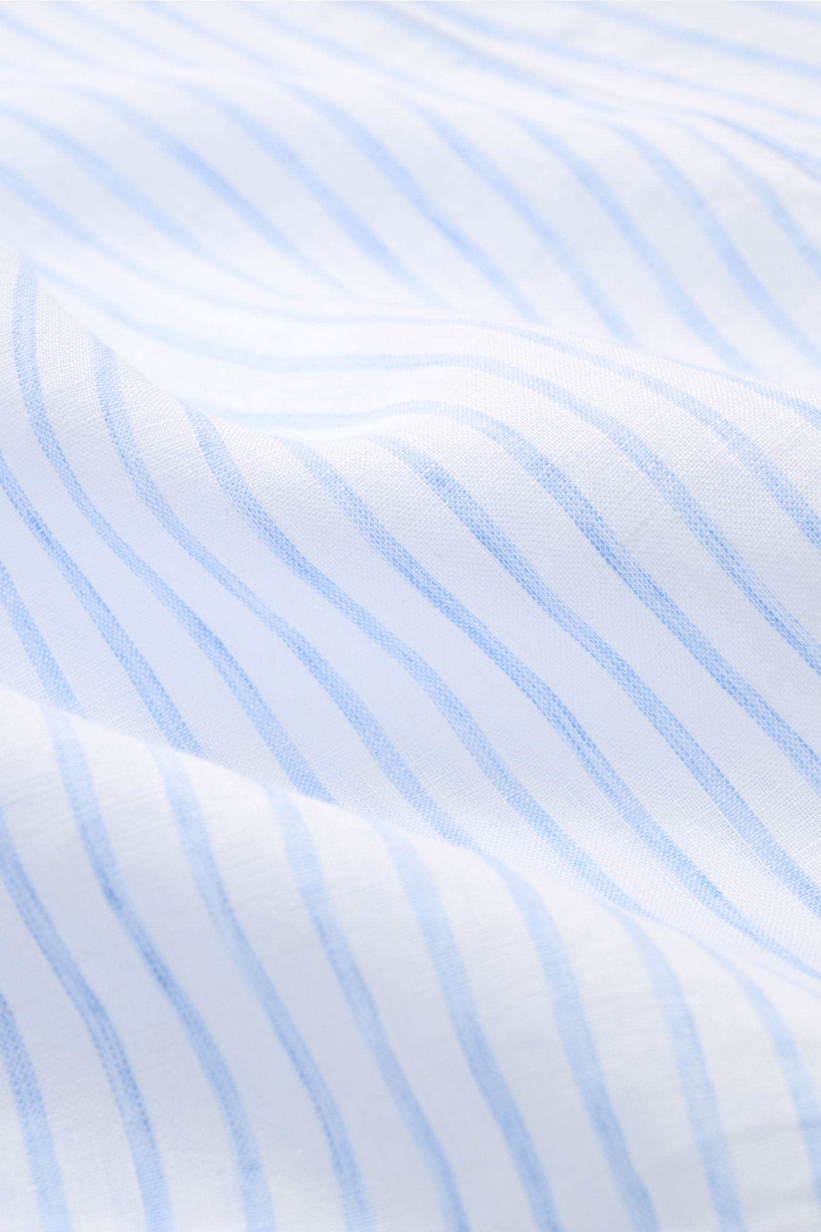 Close-up front view of Finamore Linen shirt 'Sergio Gaeta' shark collar light blue/white striped fabric showing lightweight linen plain weave and soft texture.

Perfectly equipped for warm days: This linen shirt 'Sergio Gaeta' made of airy fabric in a 