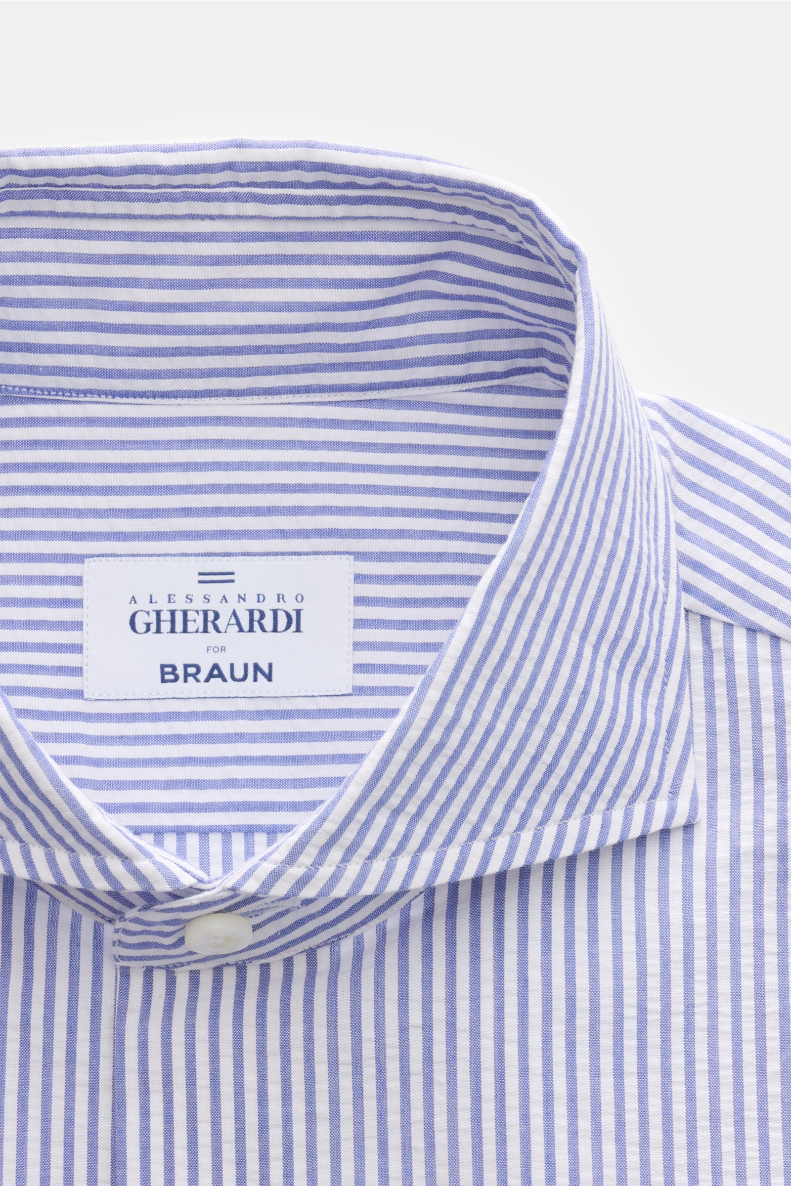 Alt tag (125 characters max): Close-up front view of Gherardi Seersucker casual shirt shark collar dark blue/white striped with label and button detail.

Description: This casual shirt by GIAMPAOLO is made of comfortable, fine seersucker fabric – a con