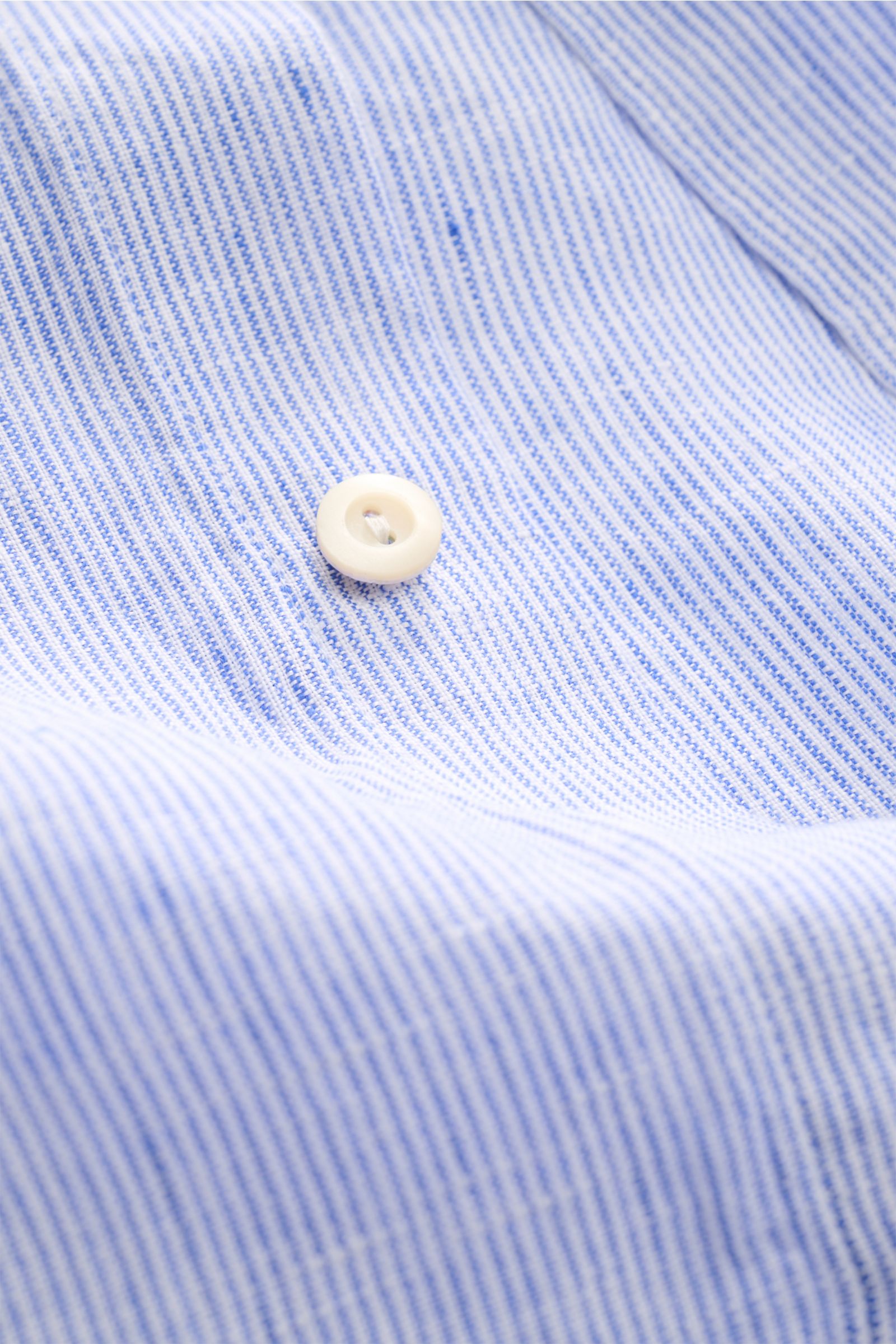 Close-up front view of von Braun Linen shirt shark collar blue/white striped showing fine striped pattern, white button, and fabric texture.

Effortlessly lightweight