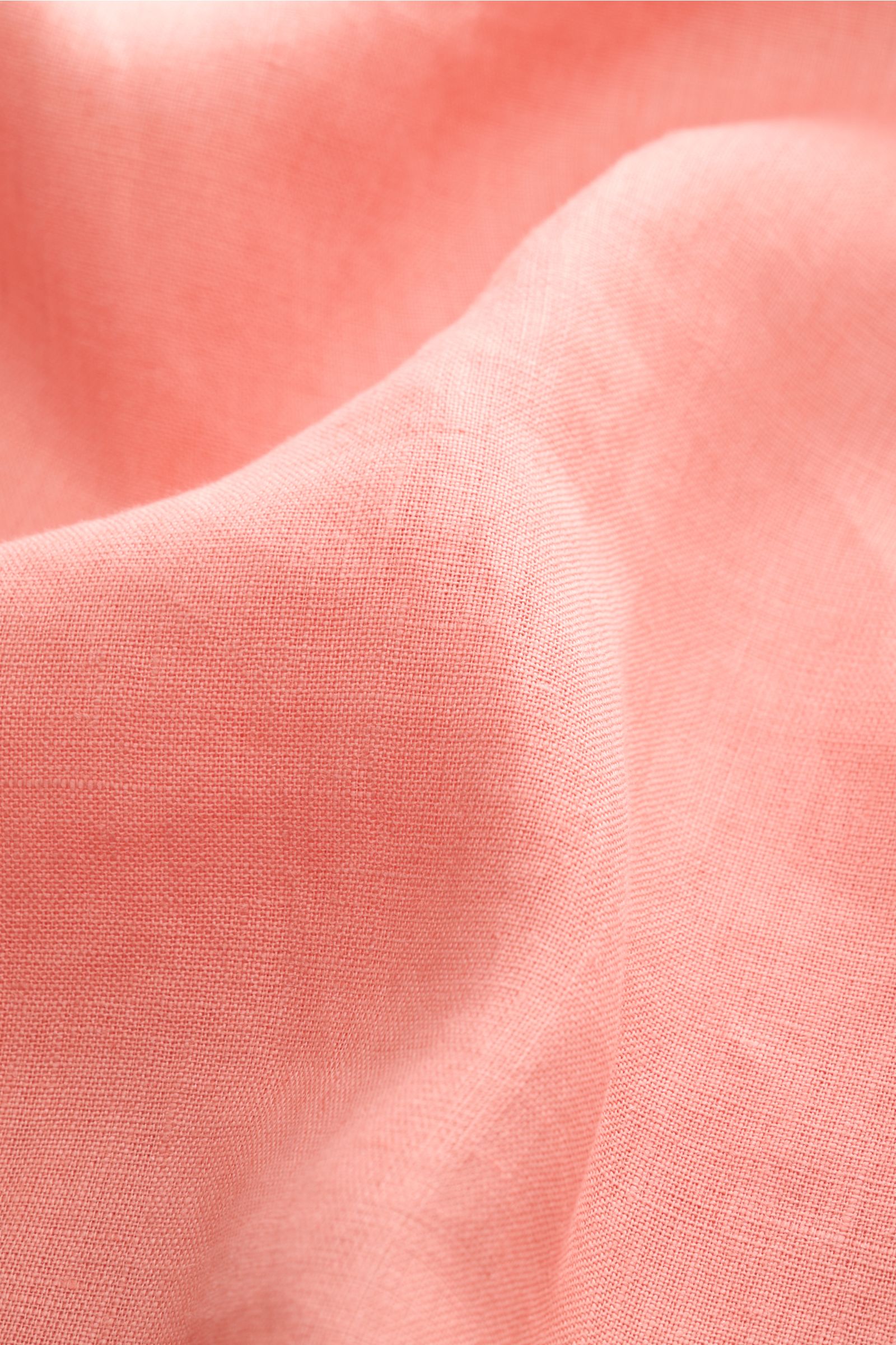 Close-up front view of coral linen fabric texture for the Aurélien Linen shirt shark collar coral, showcasing fine weave and soft feel.

Want to get into the holiday mood? With its fine linen fabric, this versatile shirt by the brand AURÉLIEN is an all