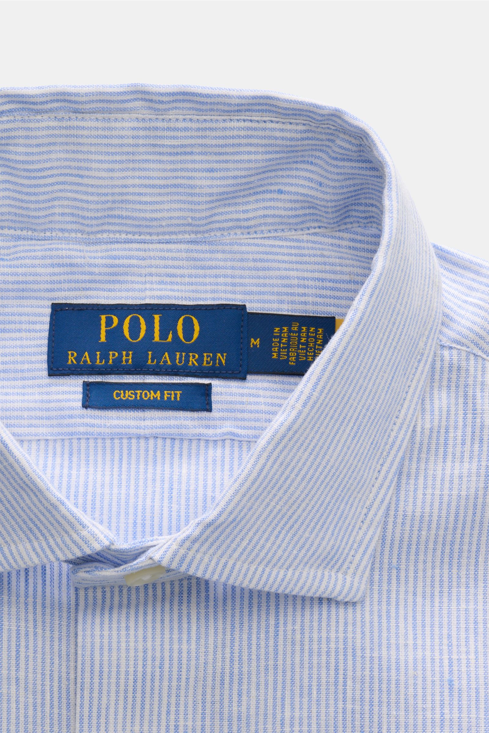 Close-up top-down view of Polo Ralph Lauren Oxford shirt shark collar light blue/white striped showing the collar and labels. 

Description: A stylish classic with attention to detail: This summery shirt by POLO RALPH LAUREN is made of linen and cotton